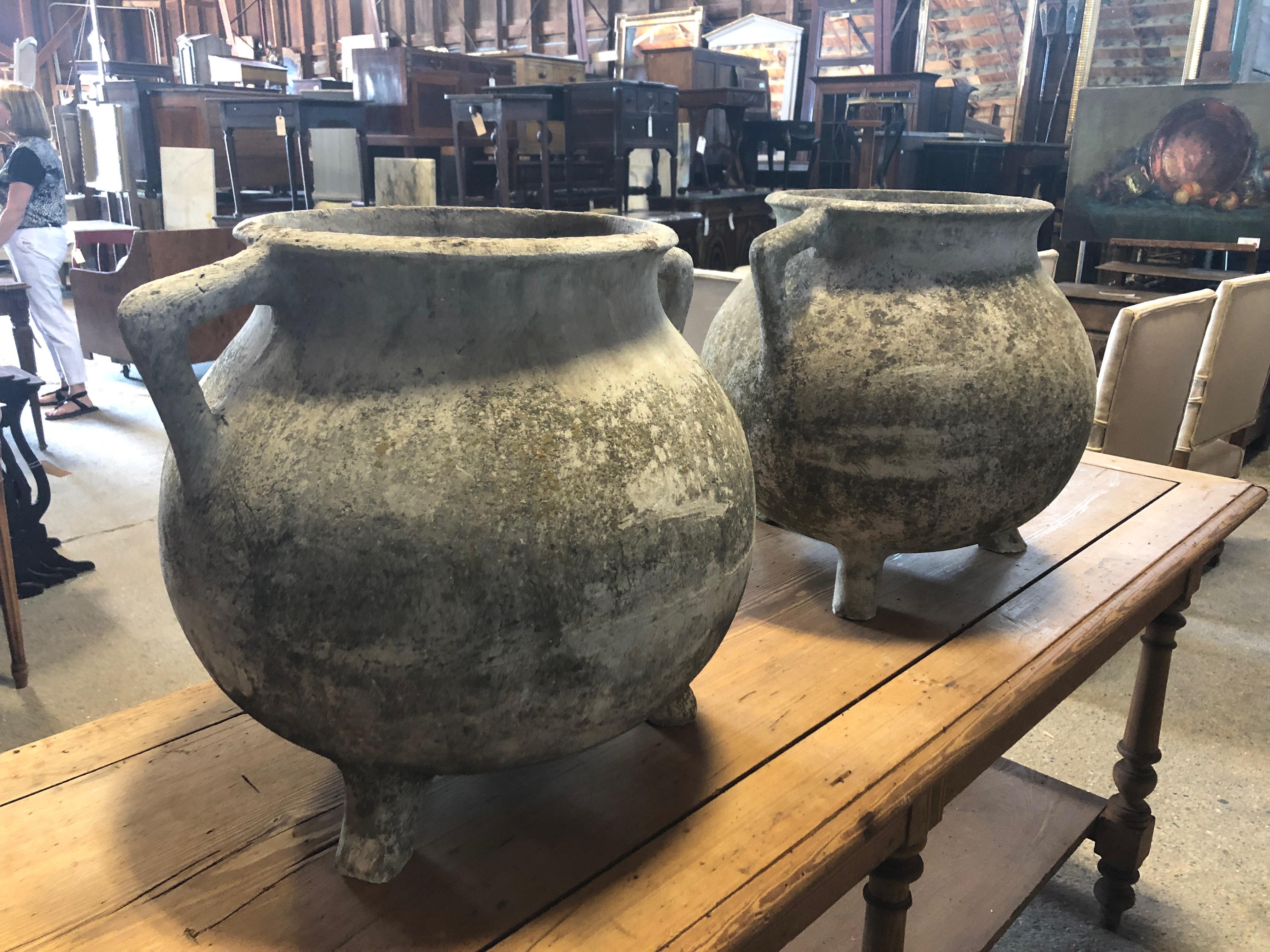 Two large French planters with wonderful earthy patina, two handles and marvelous trio of feet on each. Opening is 11 diameter.