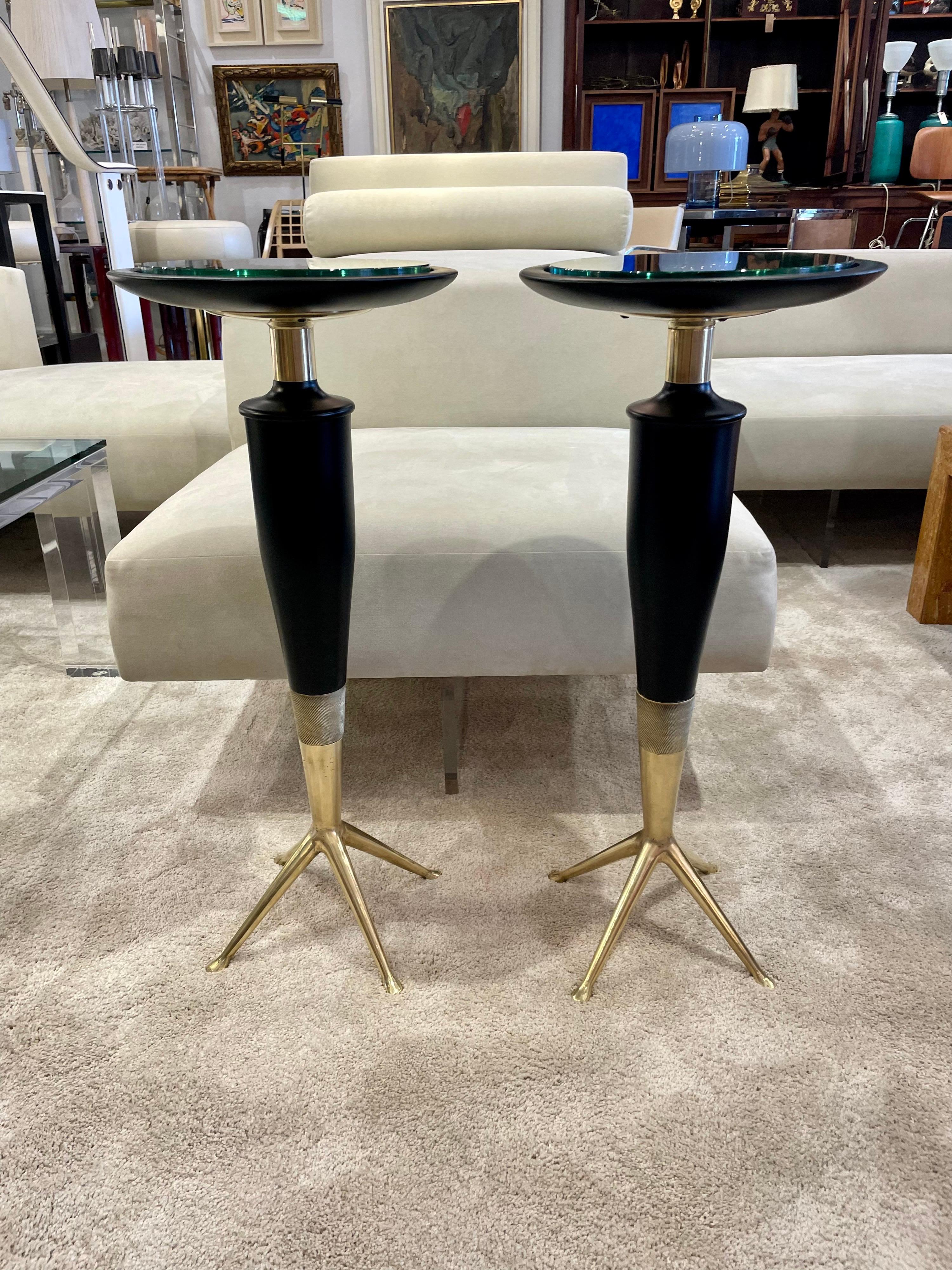 In the Manner of Gio Ponti, these outstanding drinks tables with a plateau in wood and glass inset to protect the ebonized table tops. Three wonderful legs in bronze and details abound - making these little beauties a MUST HAVE! Dimensions: 28.5