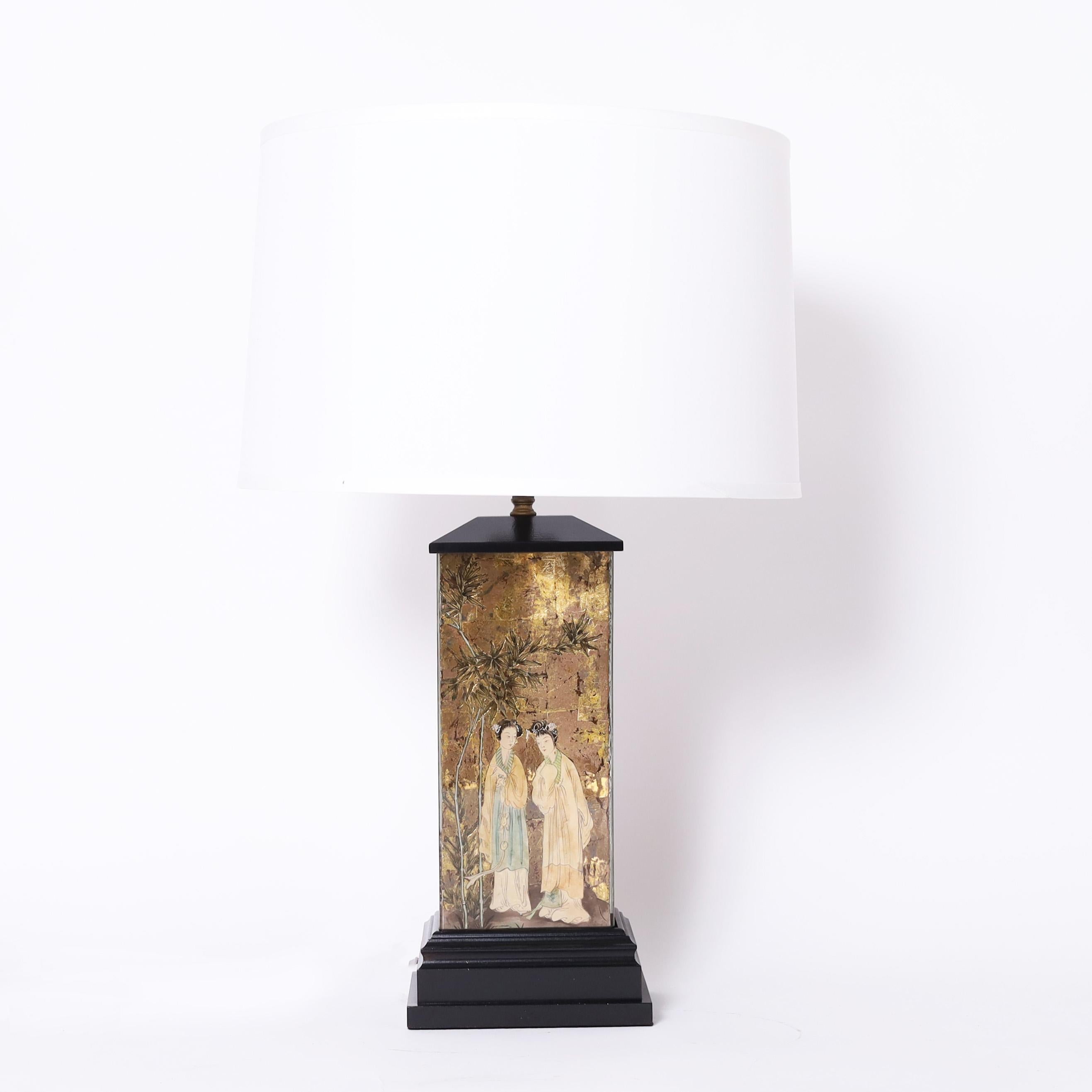 In vogue pair of mid century Italian table lamps having eglomise panels decorated in chinoiserie against gold leaf backgrounds and presented on classic black lacquer bases.