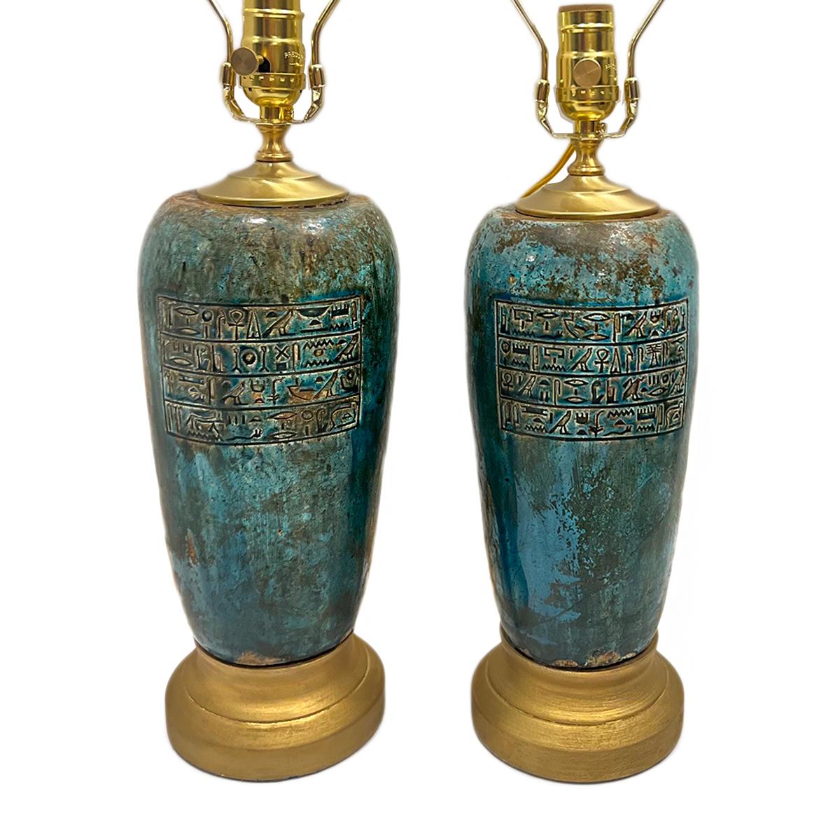 Pair of 1950's turquoise marble table lamps with hieroglyphic motif.

Measurements:
Height of body: 14