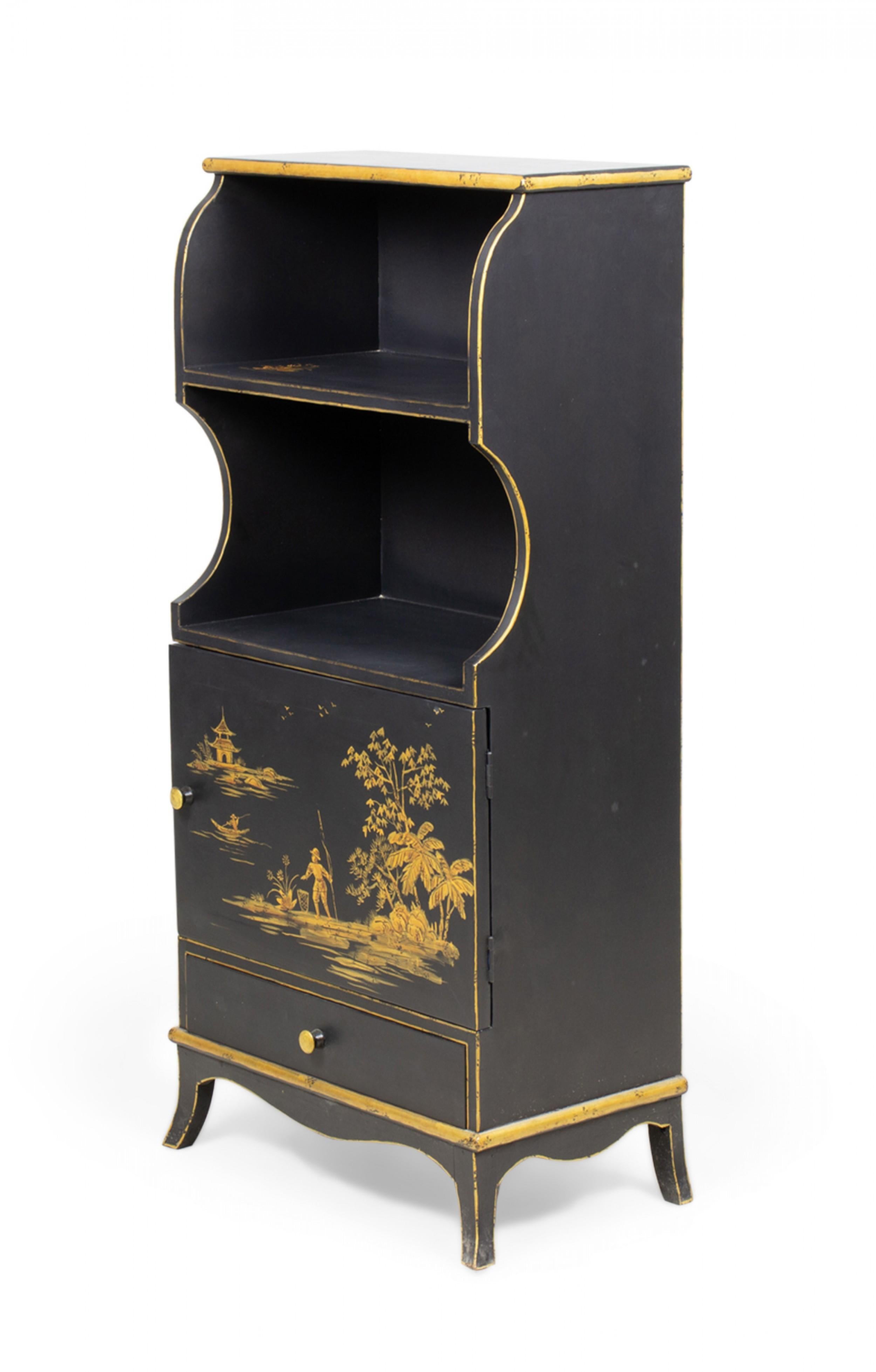 Pair of Vintage English Chinoiserie-style black bookcases with two shelves each over a solid cabinet base painted with gold pastoral scenes of figures fishing next to a lake. (PRICED AS Pair)

One bookshelf has a loose leg.