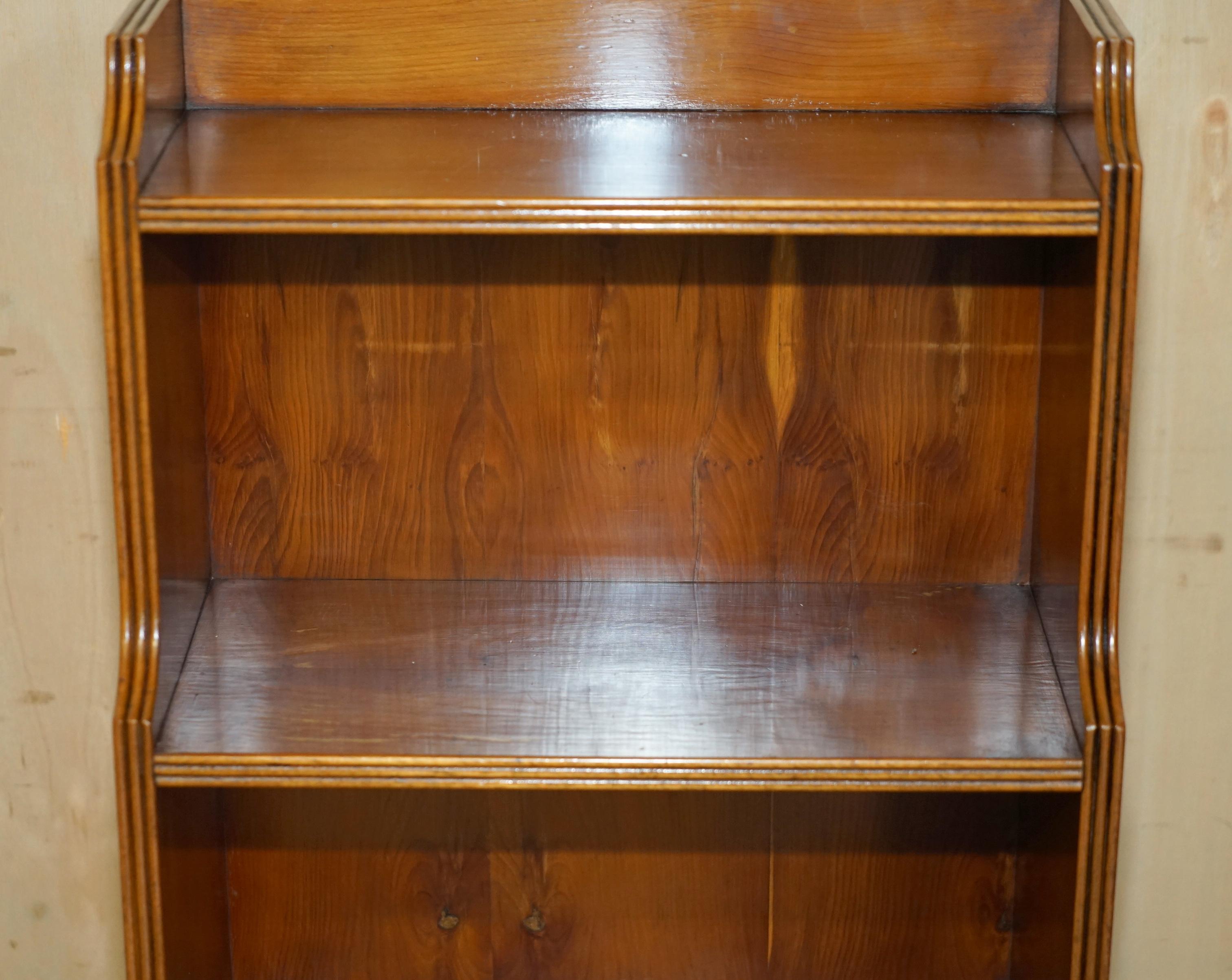 20th Century PAIR OF ViNTAGE ENGLISH FLAMED HARDWOOD WATERFALL BOOKCASES WITH CUPBOARD BASES For Sale