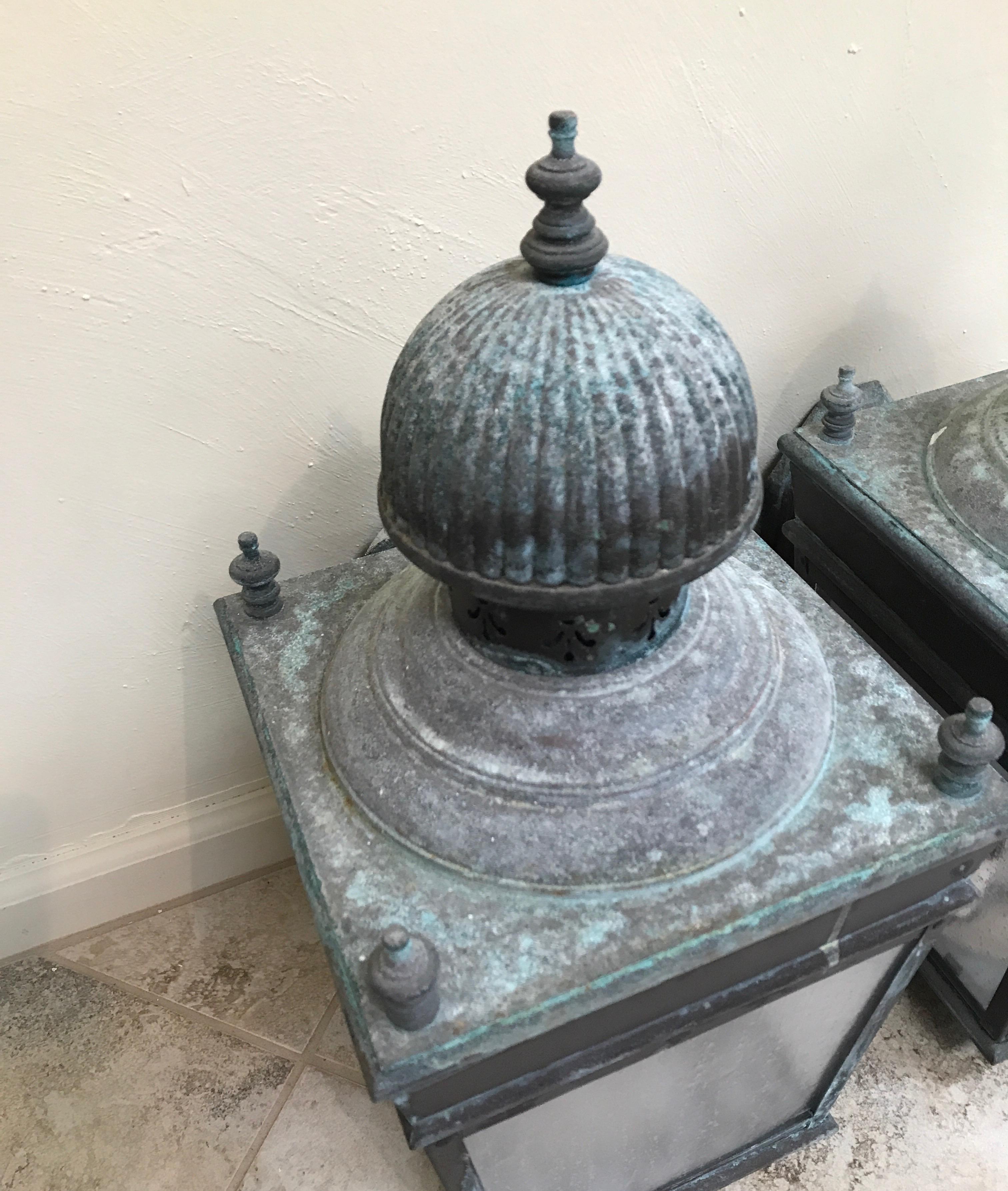 Pair of large scale brass lanterns with natural patina.