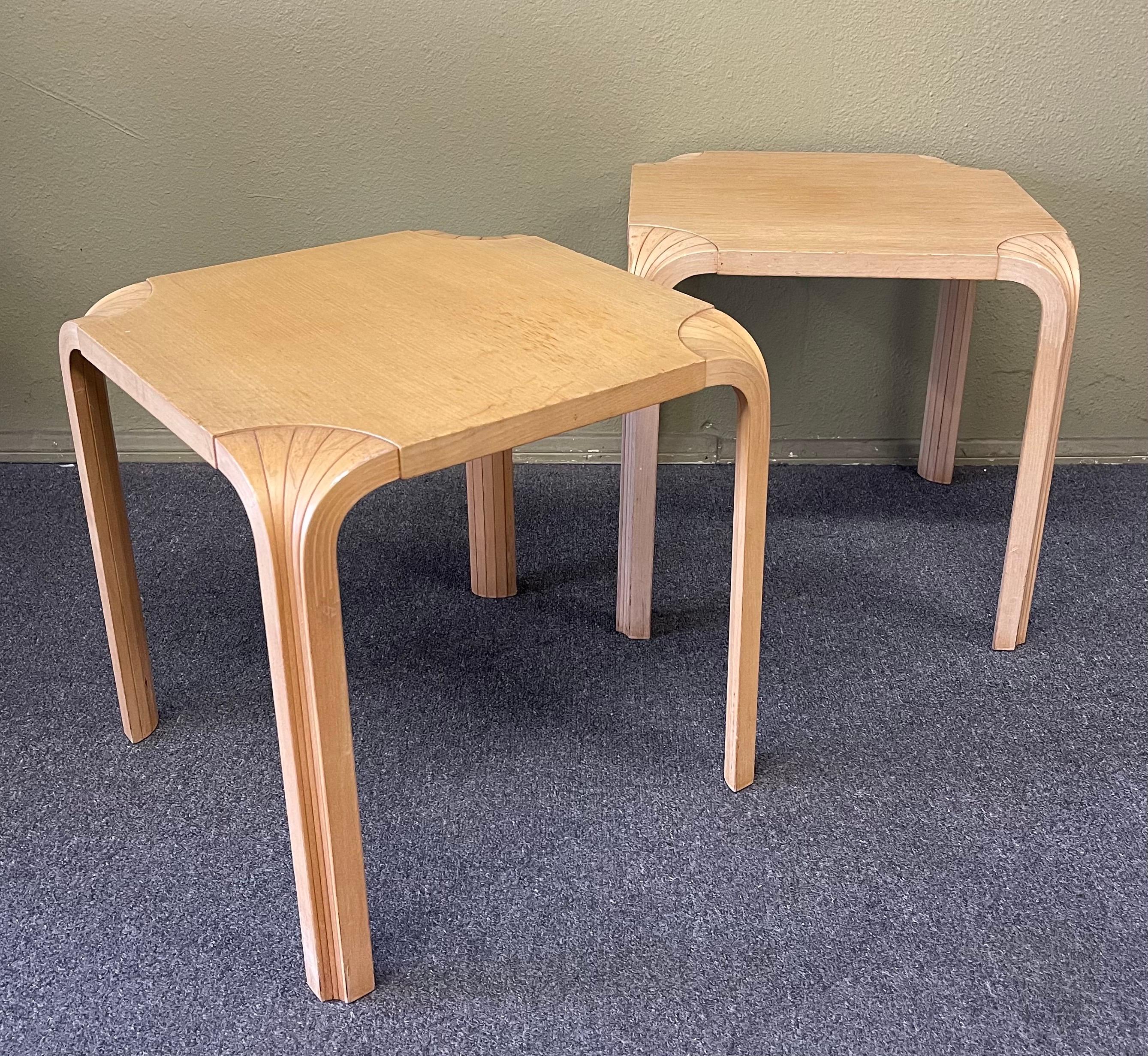 Pair of vintage fan leg side tables / stools by Alvar Aalto Designs for Artek, circa 1950s. The tables are made of birch bentwood with Aalto’s signature feathered bentwood leg design; made in Finland. The tables are in fair original vintage