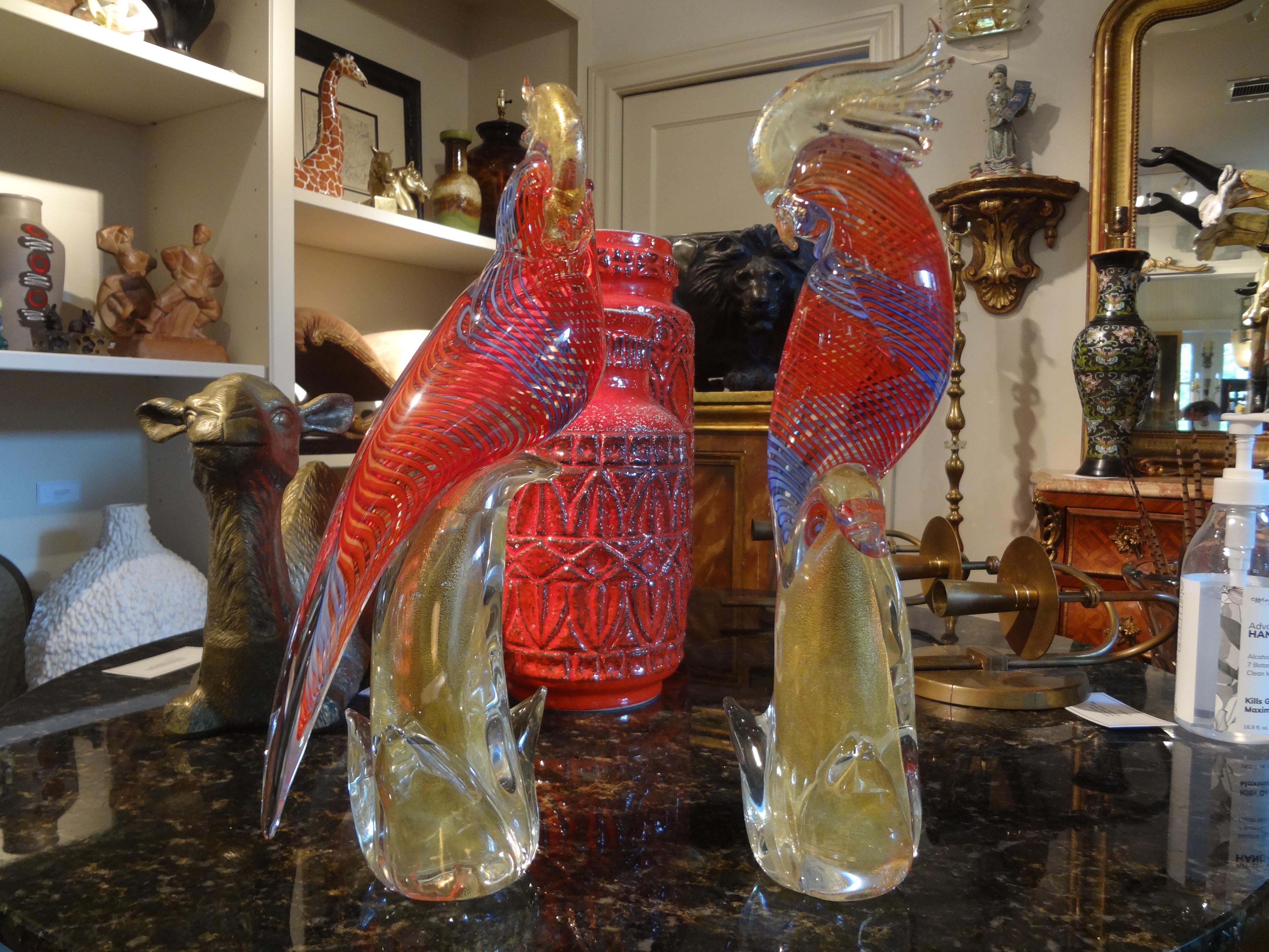 Beautiful pair of vintage Formia Murano glass parrots or cockatoos. This realistic pair of hand blown Murano glass birds are executed in beautiful shades of orange, blue and gold.