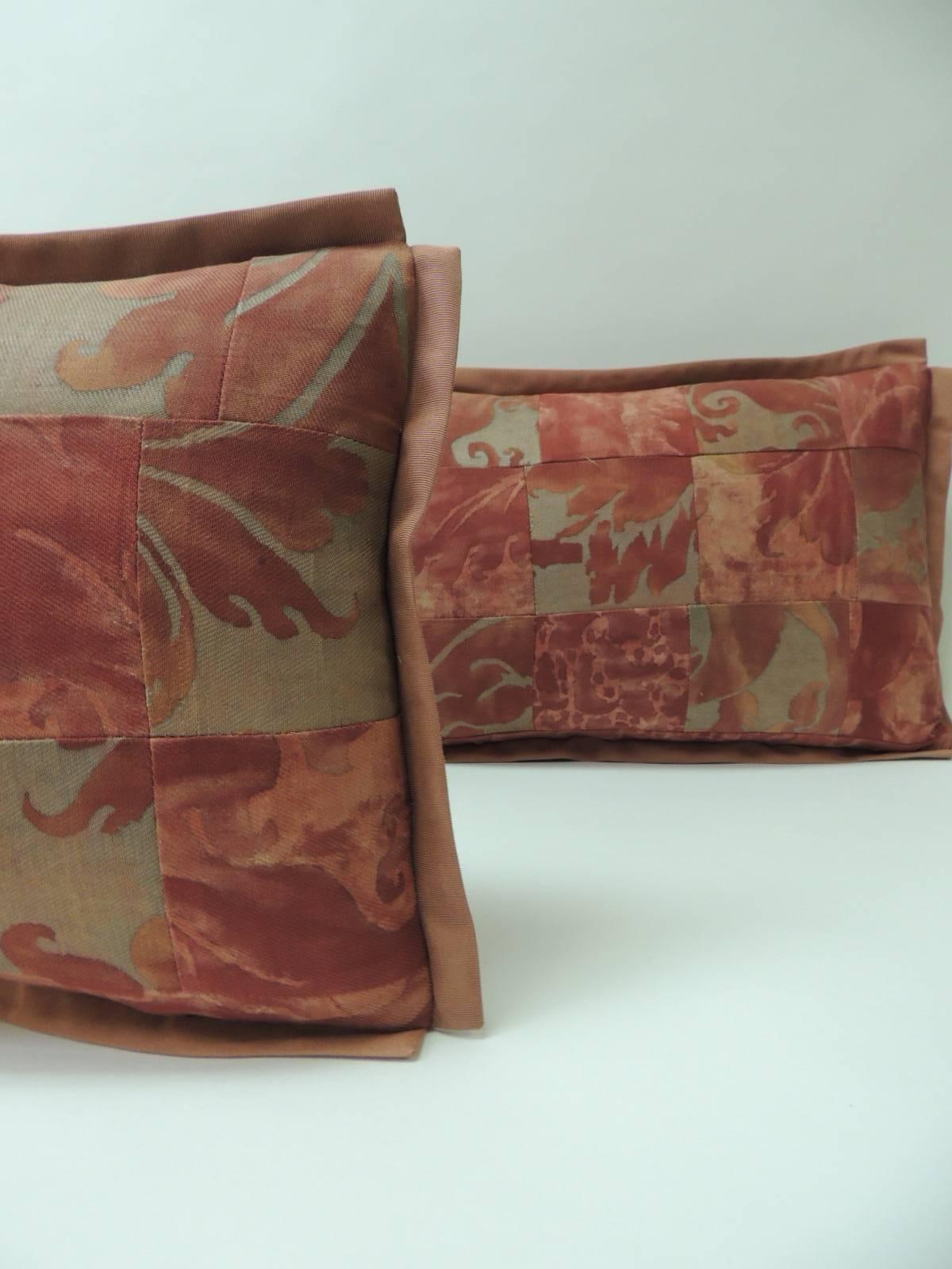 Pair of vintage Fortuny “Glicine” pattern red and silvery decorative lumbar pillows.
Large squares of textiles using them as a patchwork pattern using front and reverse side of the Fortuny textile. Accentuated with silk French pink grosgrain ribbon