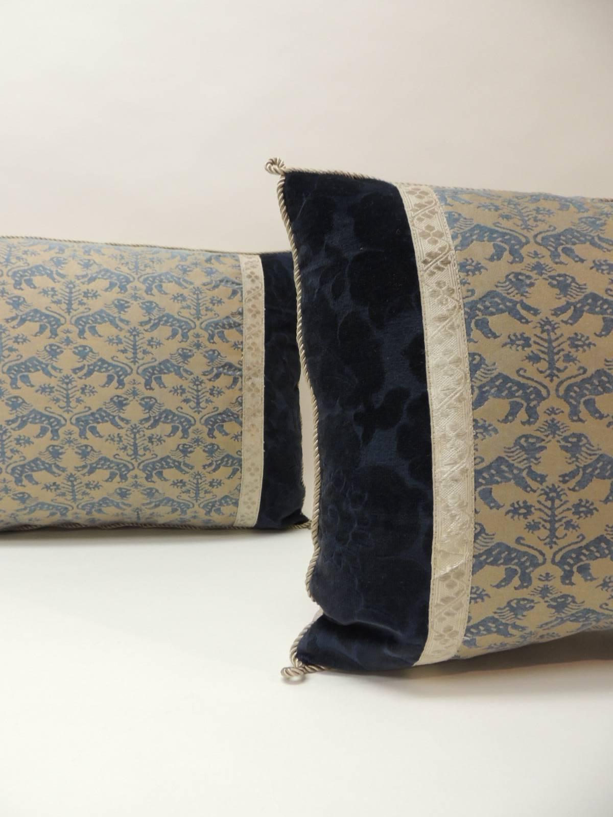 Pair of vintage Fortuny “Richelieu” blue on silver decorative bolster pillows, framed with antique cotton floral velvet and embellished with antique silver metallic tape trim. Accentuated with silk rope trim. Golden silk backings.
Decorative pillows