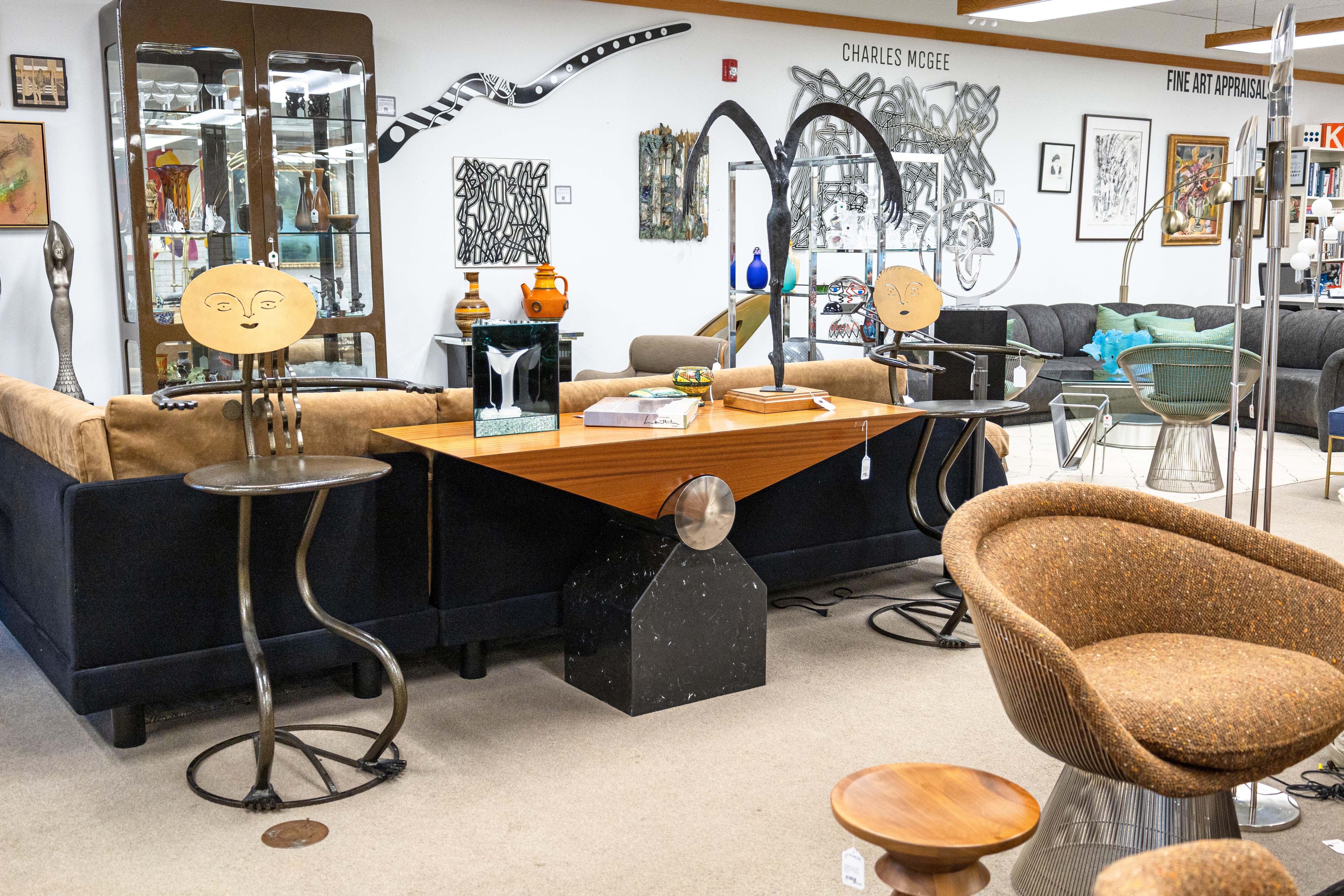 A pair of Fred Garbotz he and she bistro barstools. A wonderful eclectic pair of barstools. These pieces are designed and made by Fred Garbotz for Rockledge Design Studios. Made to order, these pieces are made with welded steel and finished with a