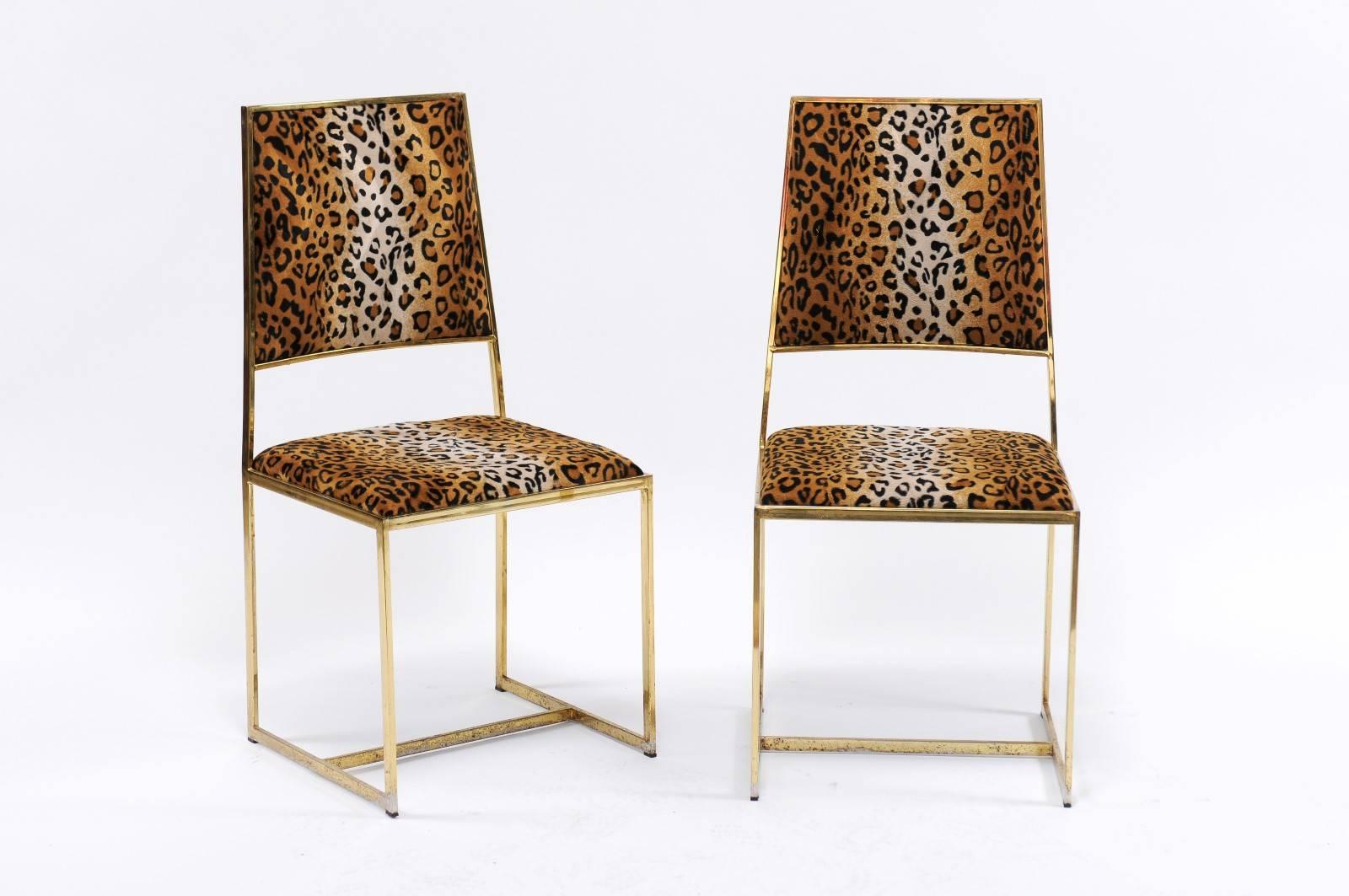 A pair of French vintage animal print upholstered side chairs with brass armature from the 1970s. We currently have two pairs available, priced and sold per pair. We had our eye on this pair of sleek animal print and brass chairs for quite a while,