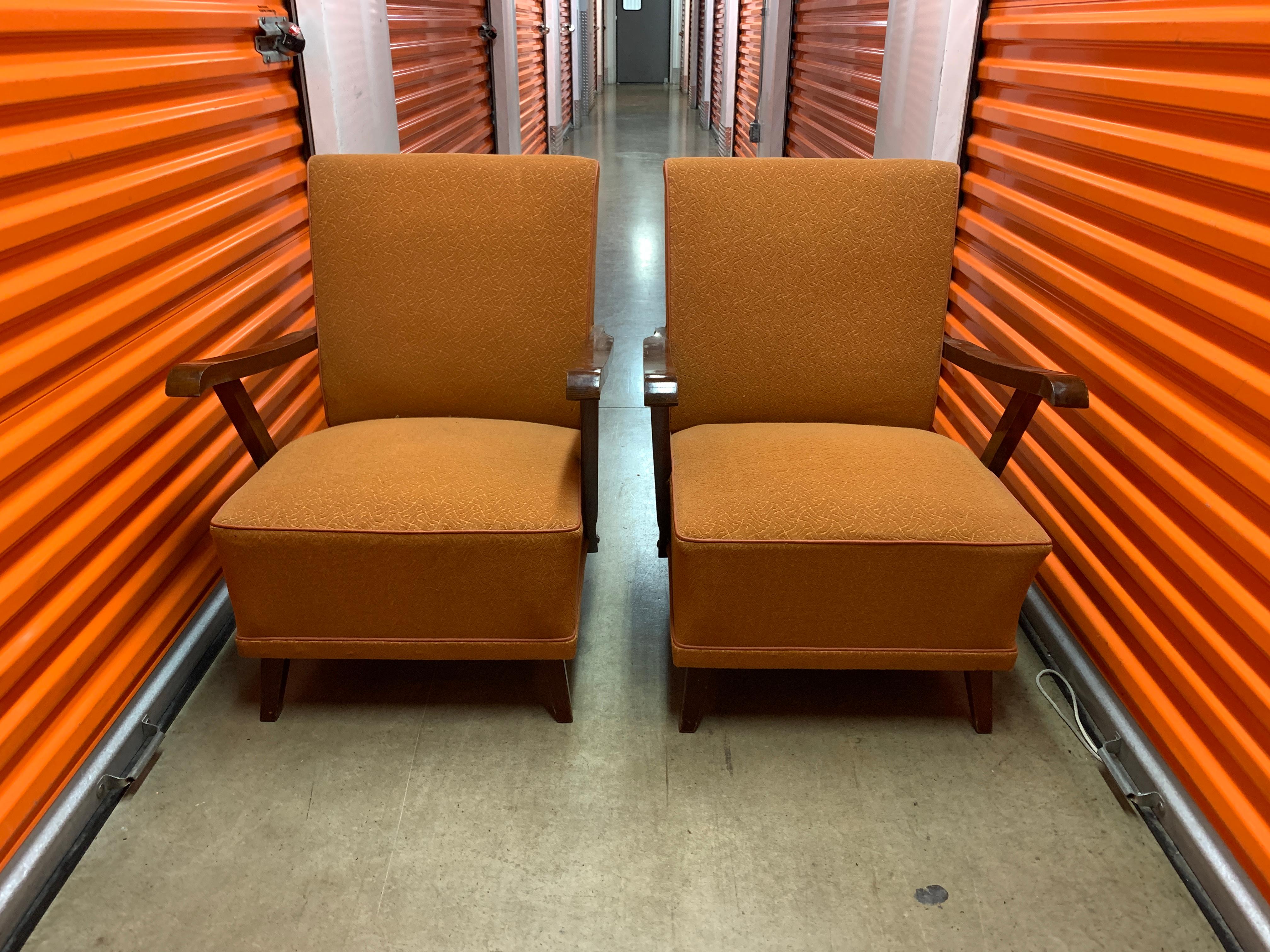 This pair of Vintage orange armchairs illustrate the simplistic and sharp-lines of the Art Deco period.