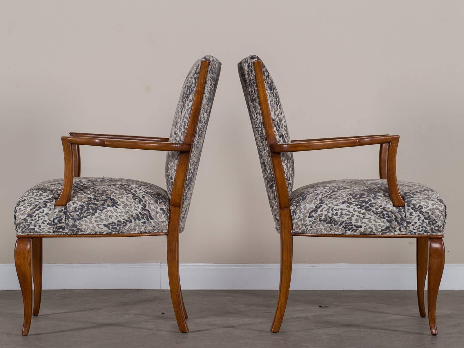 A pair of vintage French Art Deco beechwood armchairs circa 1940 now reupholstered in a contemporary fabric. Please notice the gently curved back that has a flared profile as well as the elegant shape to the legs that give these Art Deco chairs