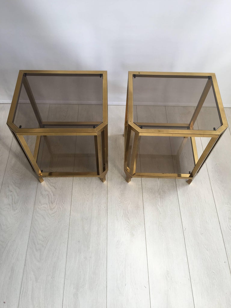 Great shape to this pair of side tables from France, circa 1970.

Brass plate with aged patina and smoked glass shelves

please note small amount of discolouration near bottom of left table (see close up image)

Measuring 40cm wide, 35cm deep