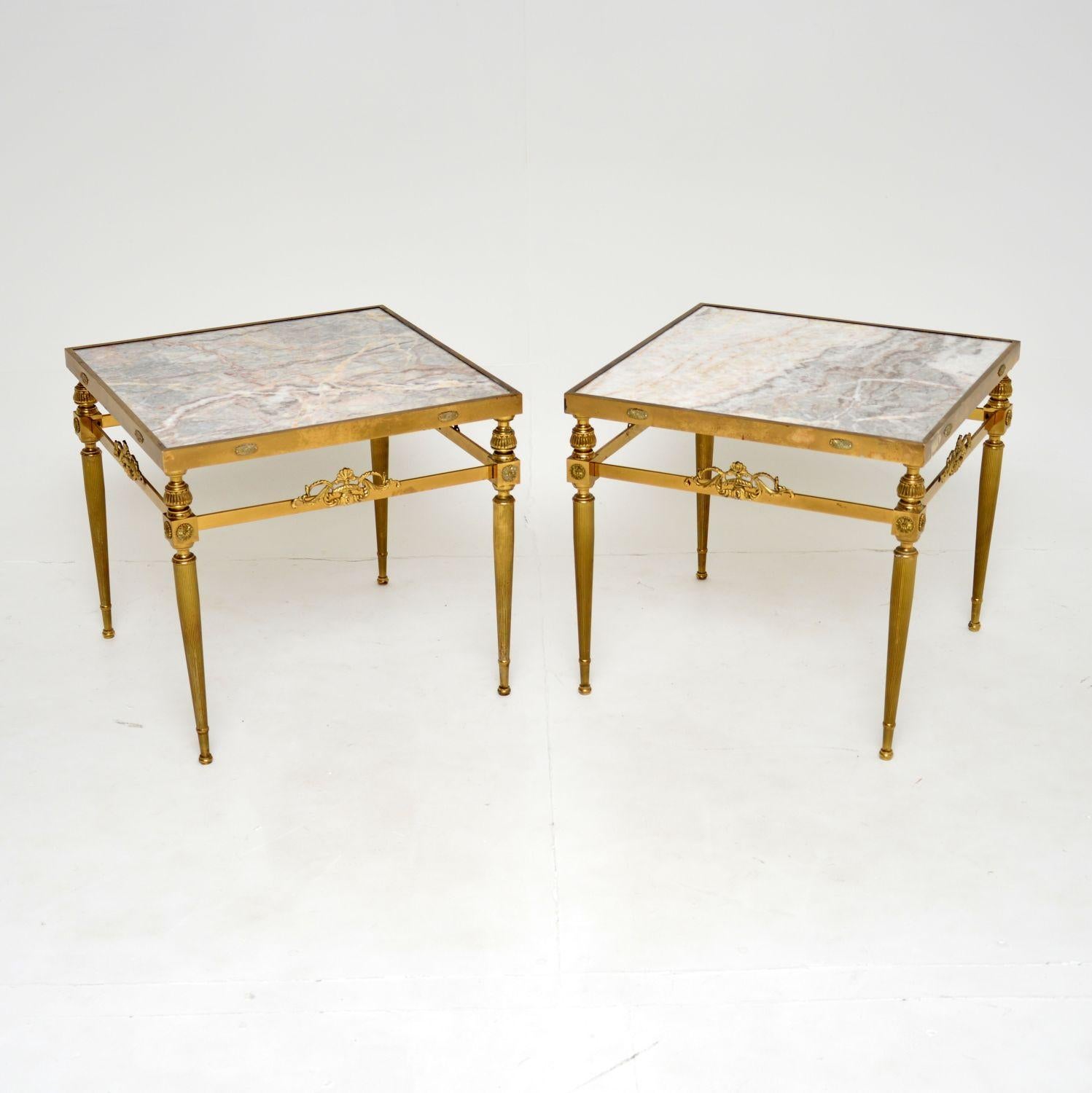 A beautiful pair of vintage solid brass side tables with inset marble tops. These were made in France, they date from the 1950-60’s.

They are of super quality and have a stunning design. The solid brass frames have fluted legs and wonderful