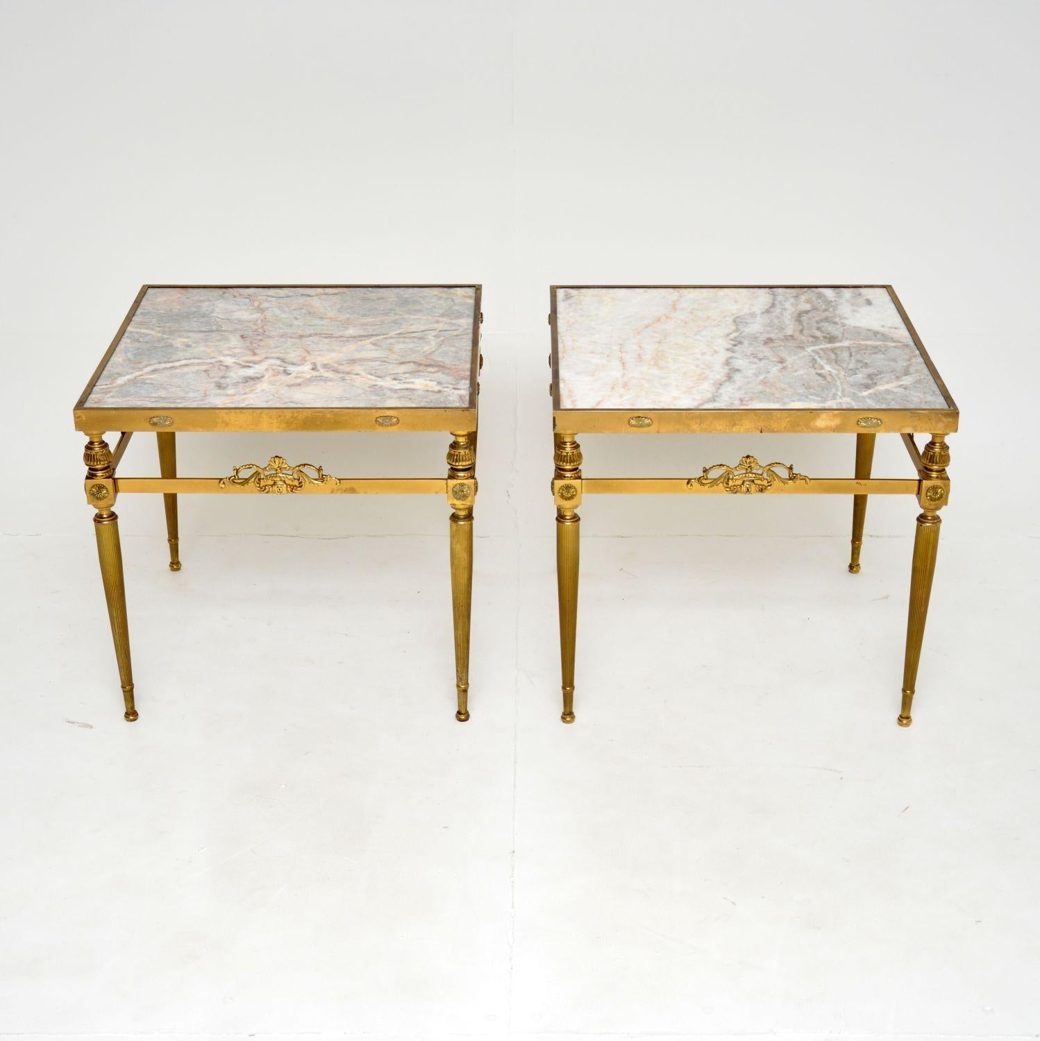 A beautiful pair of vintage solid brass side tables with inset marble tops. These were made in France, they date from the 1950-60’s.

They are of super quality and have a stunning design. The solid brass frames have fluted legs and wonderful