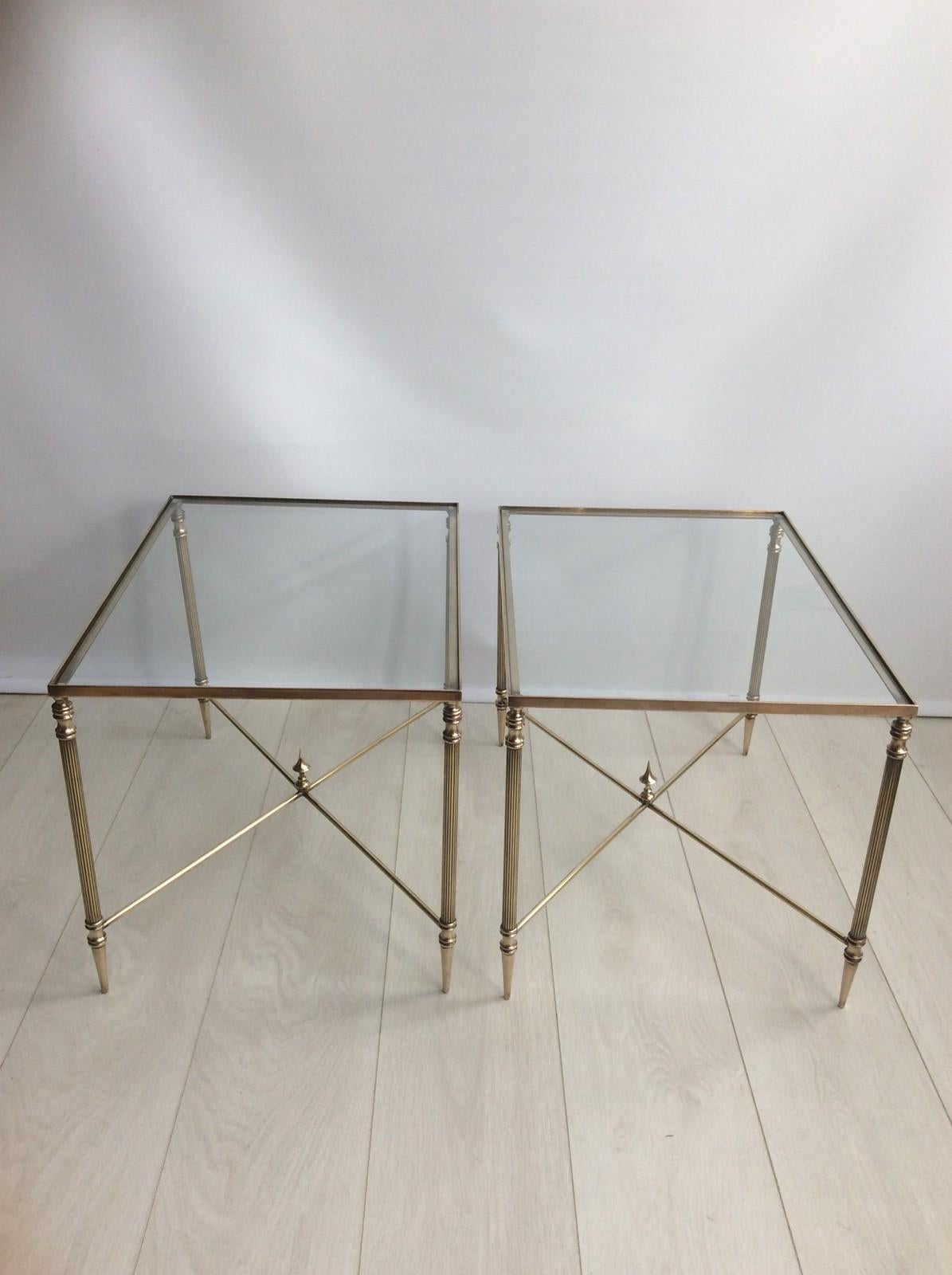 A pair of elegant brass side tables from France, circa 1950.

Measuring 53cm wide, 40cm deep
39.5cm tall.
 