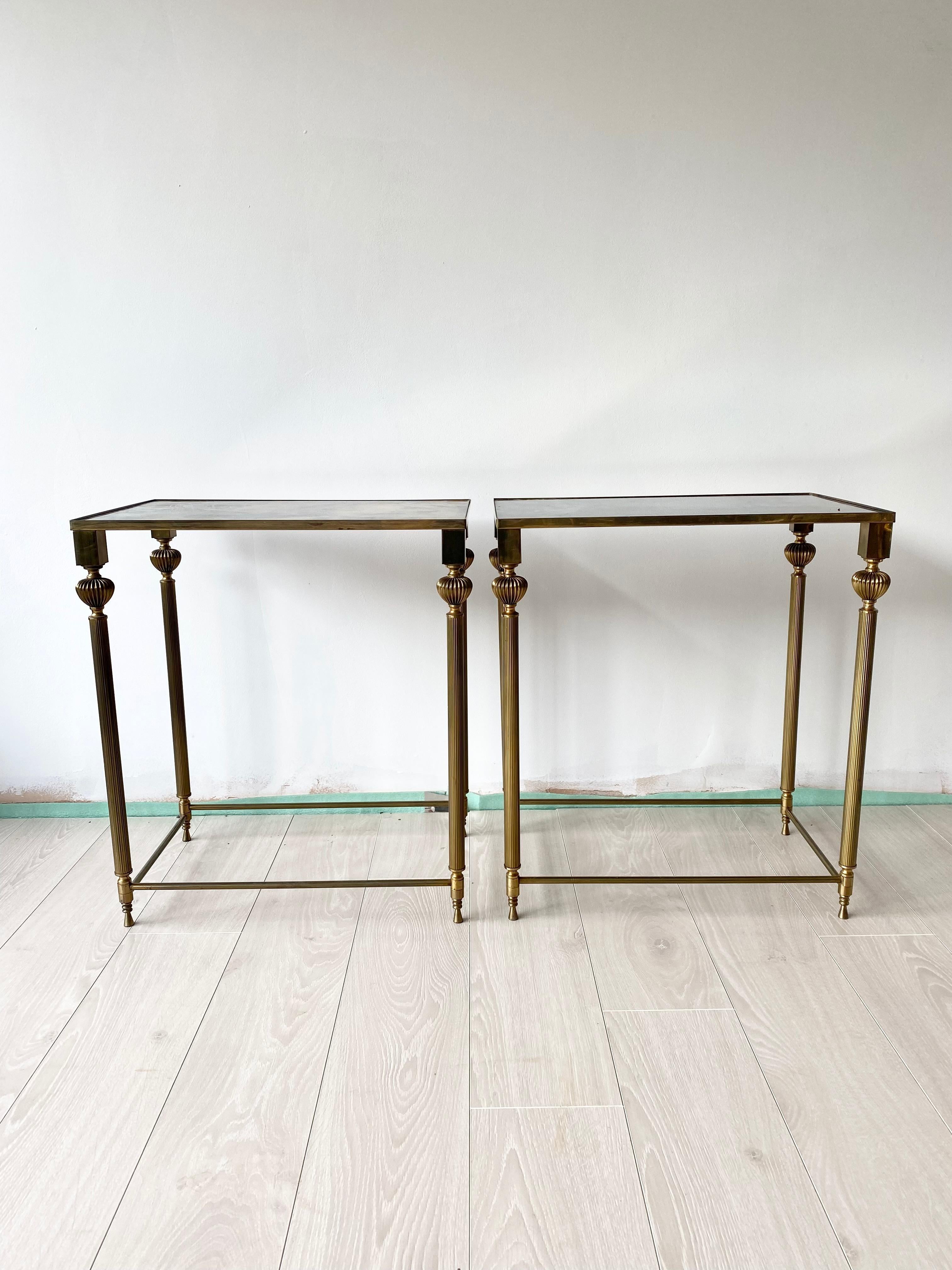 Beautiful pair of tall side tables

Aged brass frame with verre eglomise tops 

Measure 50.5cm by 32.5cm and stand 57cm tall.