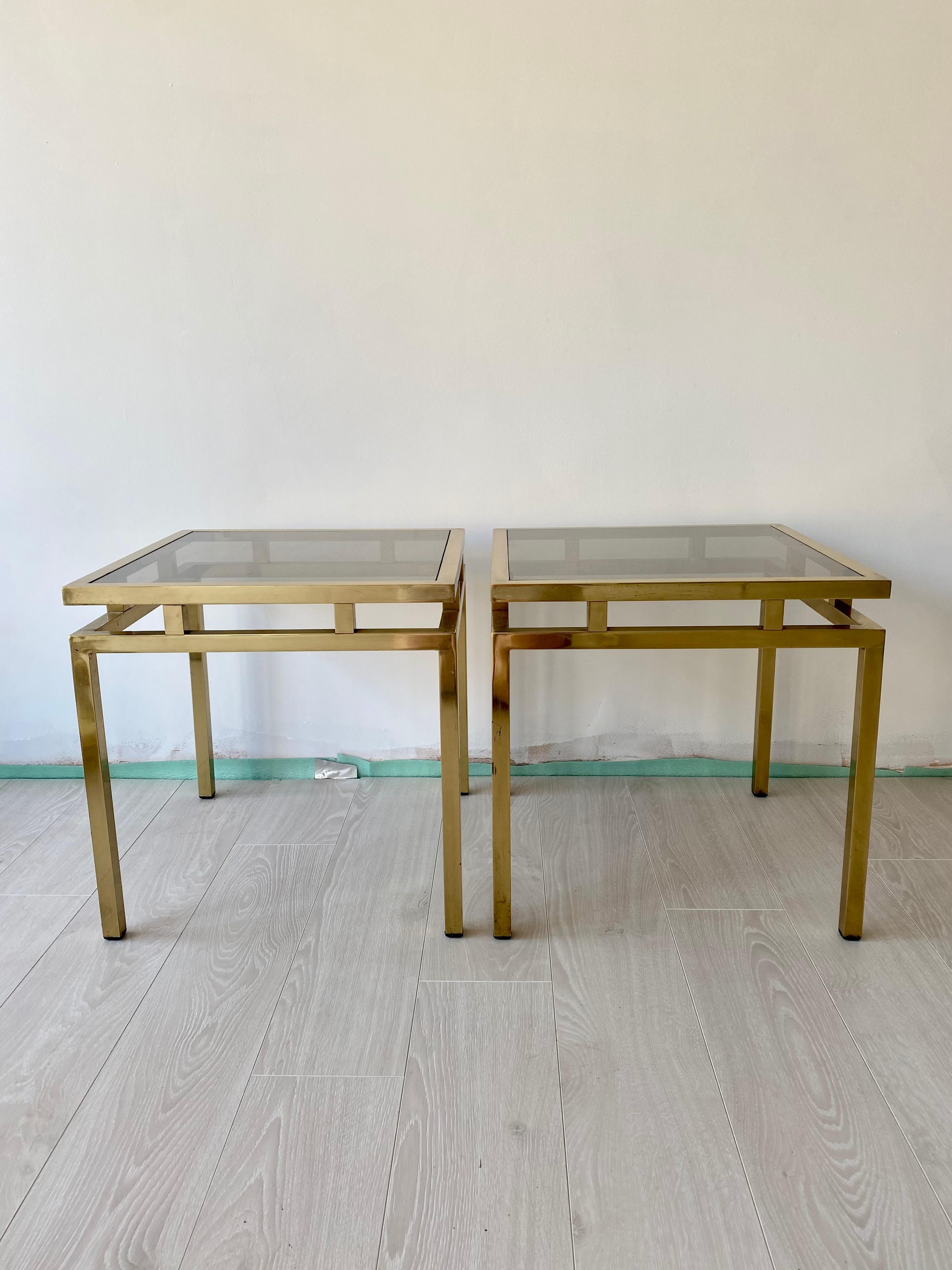 Pair of vintage French brass side tables with original smoked glass tops.

Lovely aged patina to the frame

A fabulous pair of decorative side tables which would work in both a classic and modern interior.

Measures 46cm square, stand 46cm