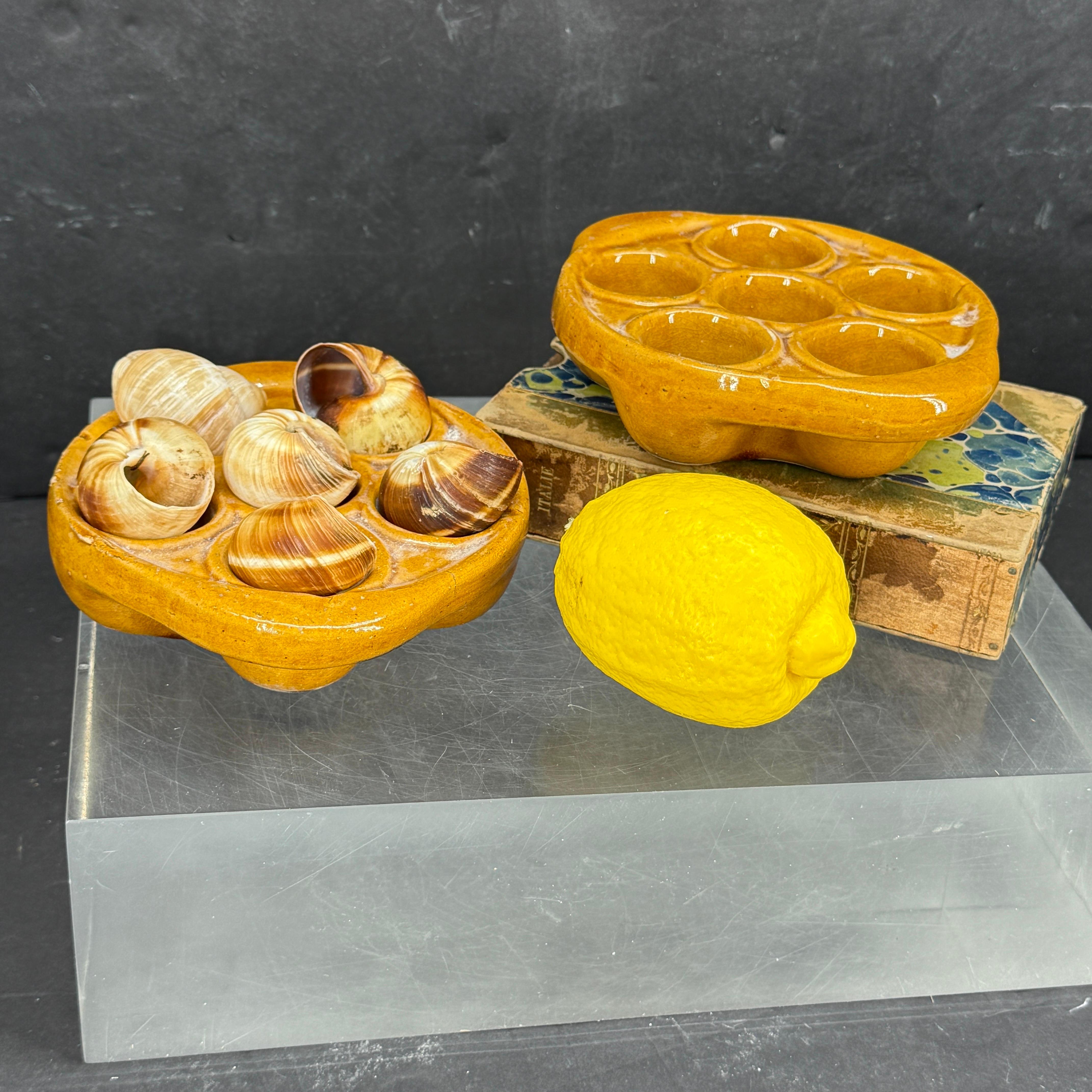 Wonderful vintage French escargot snail baking dishes found in a French market. These are designed with the indentations to hold snails cooked in their shells. Wonderful to use but also great vintage display pieces for the collector.