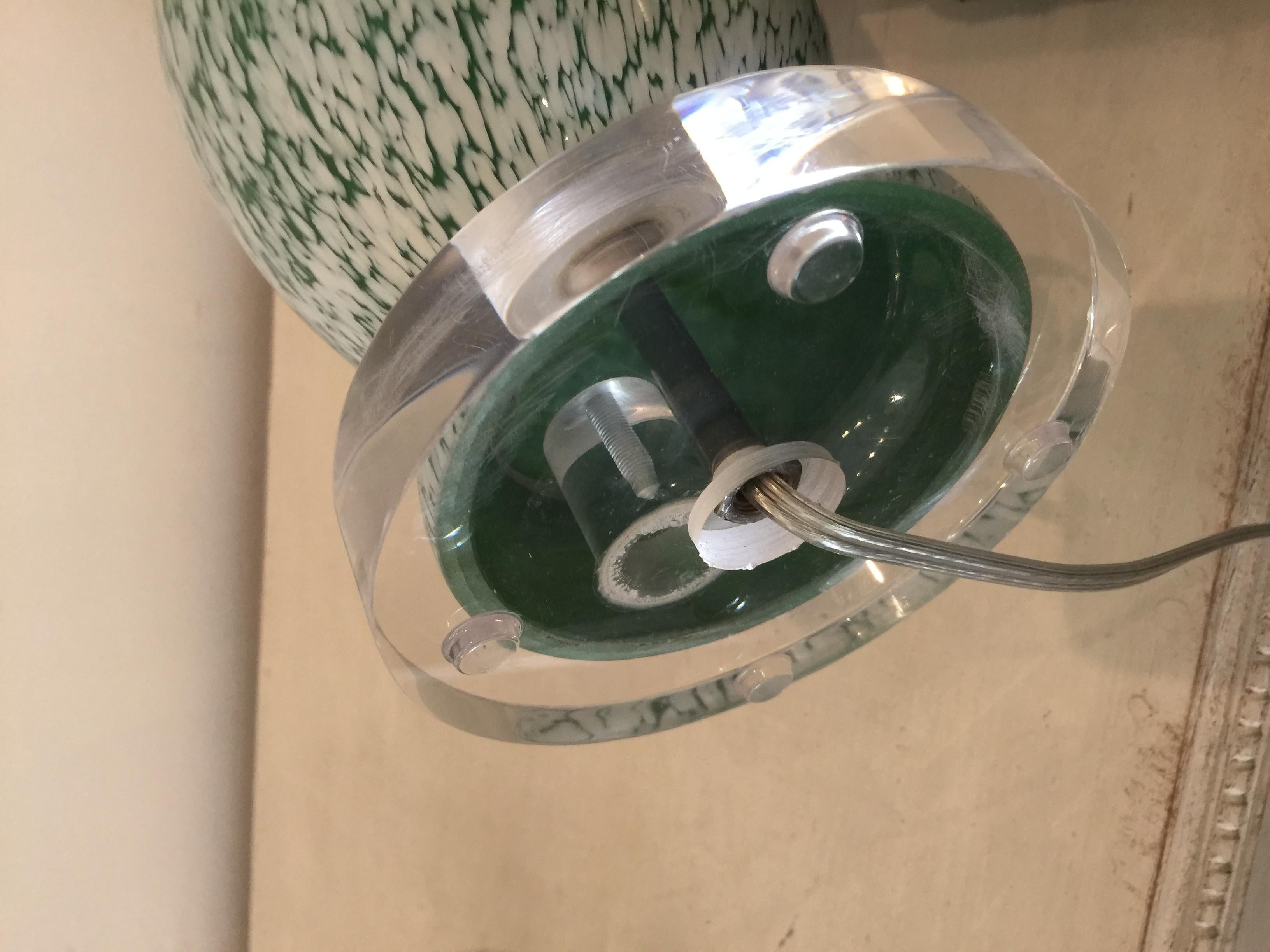 Pair of vintage green and white glass table lamps.
Made in France. Sit level and sturdy on clear Lucite bases.
Rewired to U.S. standards and can accommodate up to 150 watts. UL listed.

Measurements:
Height 21'' base to socket diameter 5''.