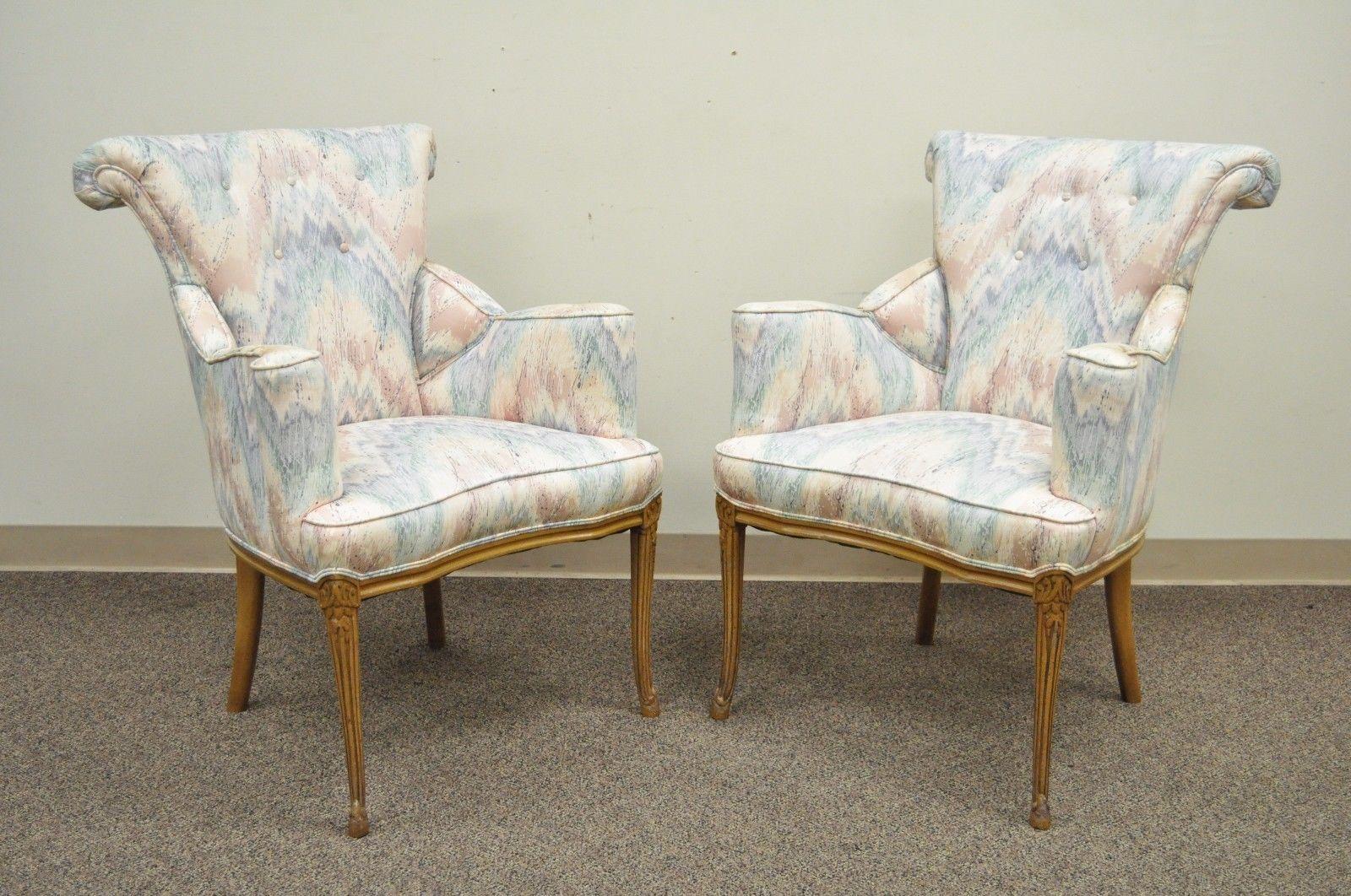 Pair of vintage Hollywood Regency French style fireside lounge chairs. Item features solid mahogany frames, rolled backs, dramatic splayed arms, and carved and tapered legs, circa 1940s, American. Measurements: 37
