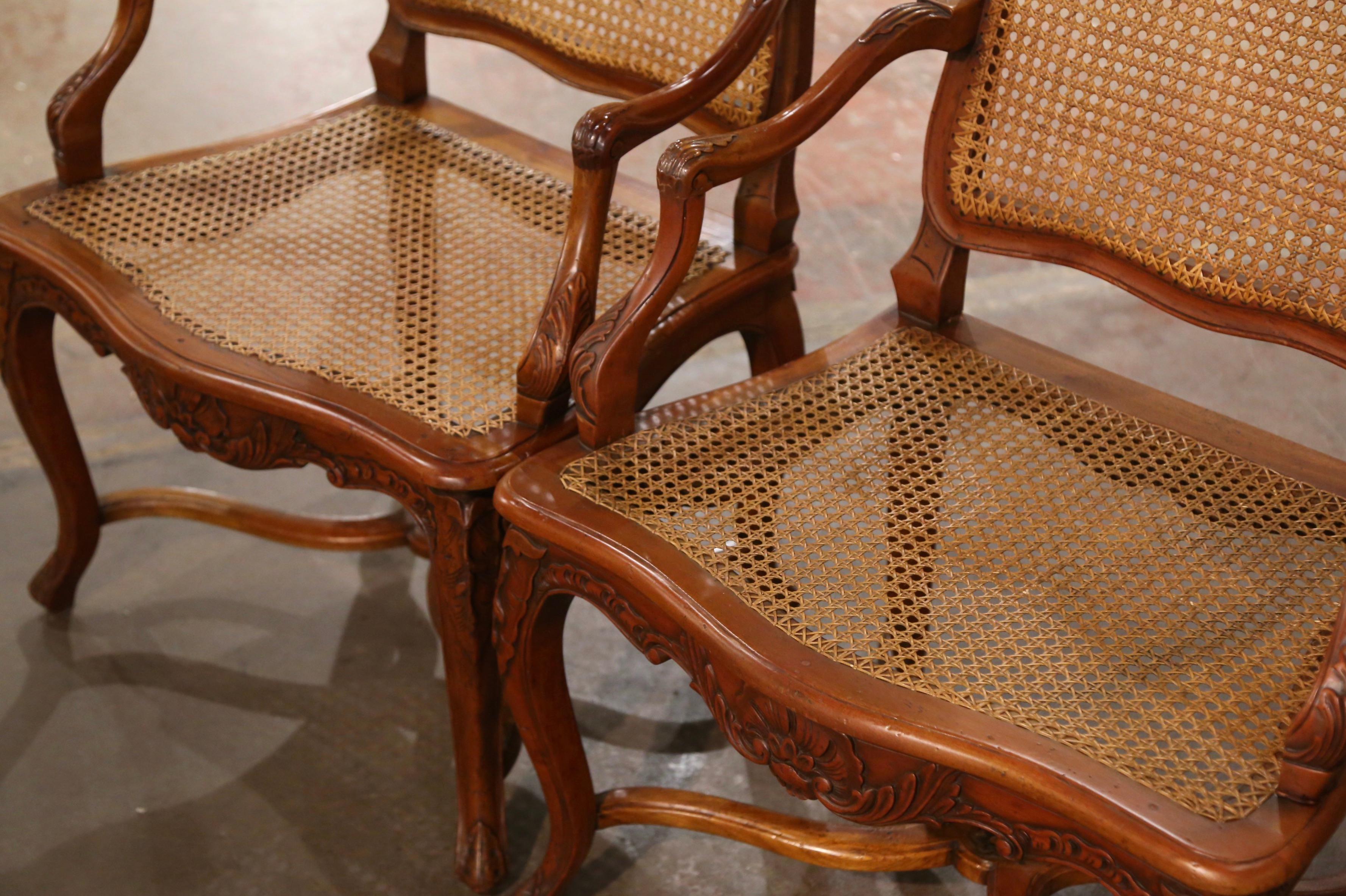 Decorate a study or office with this elegant pair of vintage armchairs. Crafted in Provence, France, circa 1990, each chair stands on cabriole legs decorated with leaf motifs at the shoulders, and ending with scroll feet over a decorative X