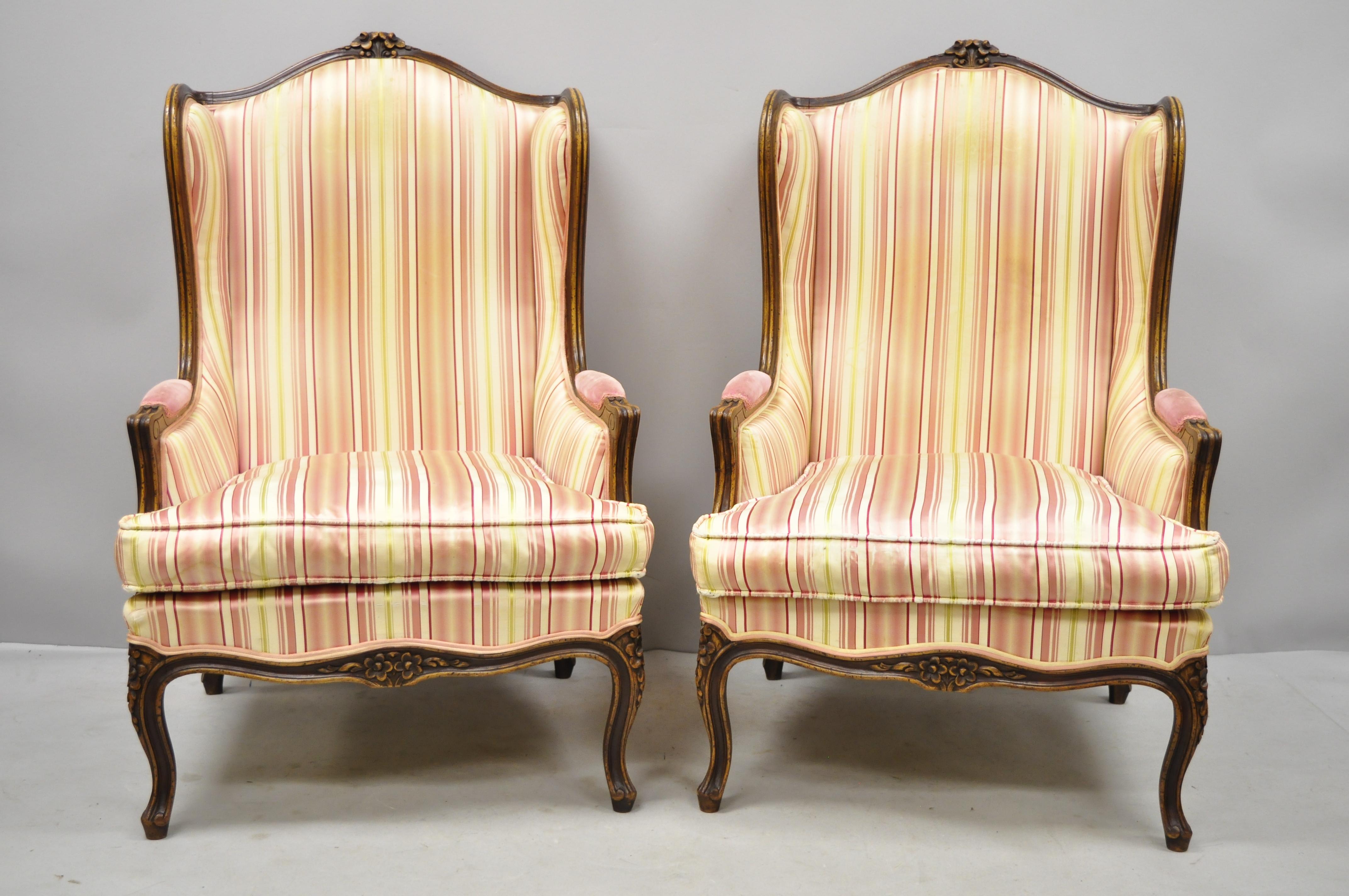 Pair of vintage French Louis XV style wingback bergere armchairs, W & J Sloane. These chairs were made in Italy, and originally sold by W & J Sloane Inc. Items feature solid wood frame, beautiful wood grain, distressed finish, nicely carved details,