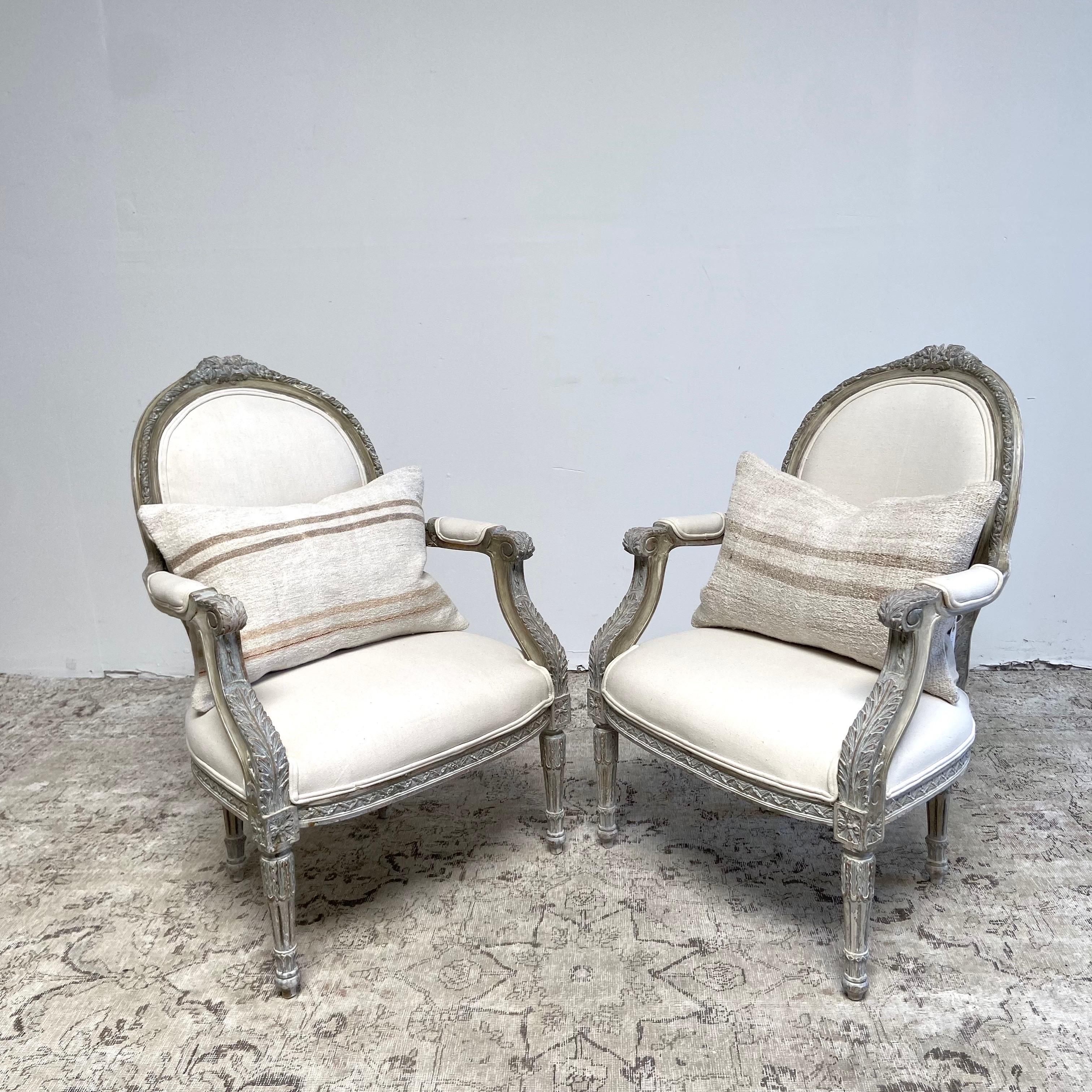 Pair open arm chairs 26”w x 27”d x 38”h
Seat H:17”. Seat D:20”. Arm H:25”
Louis XVI Style with painted gray finish with subtle distressed edges, and cotton upholtery.
Legs are solid and sturdy ready for everyday use. These can be reupholstered in