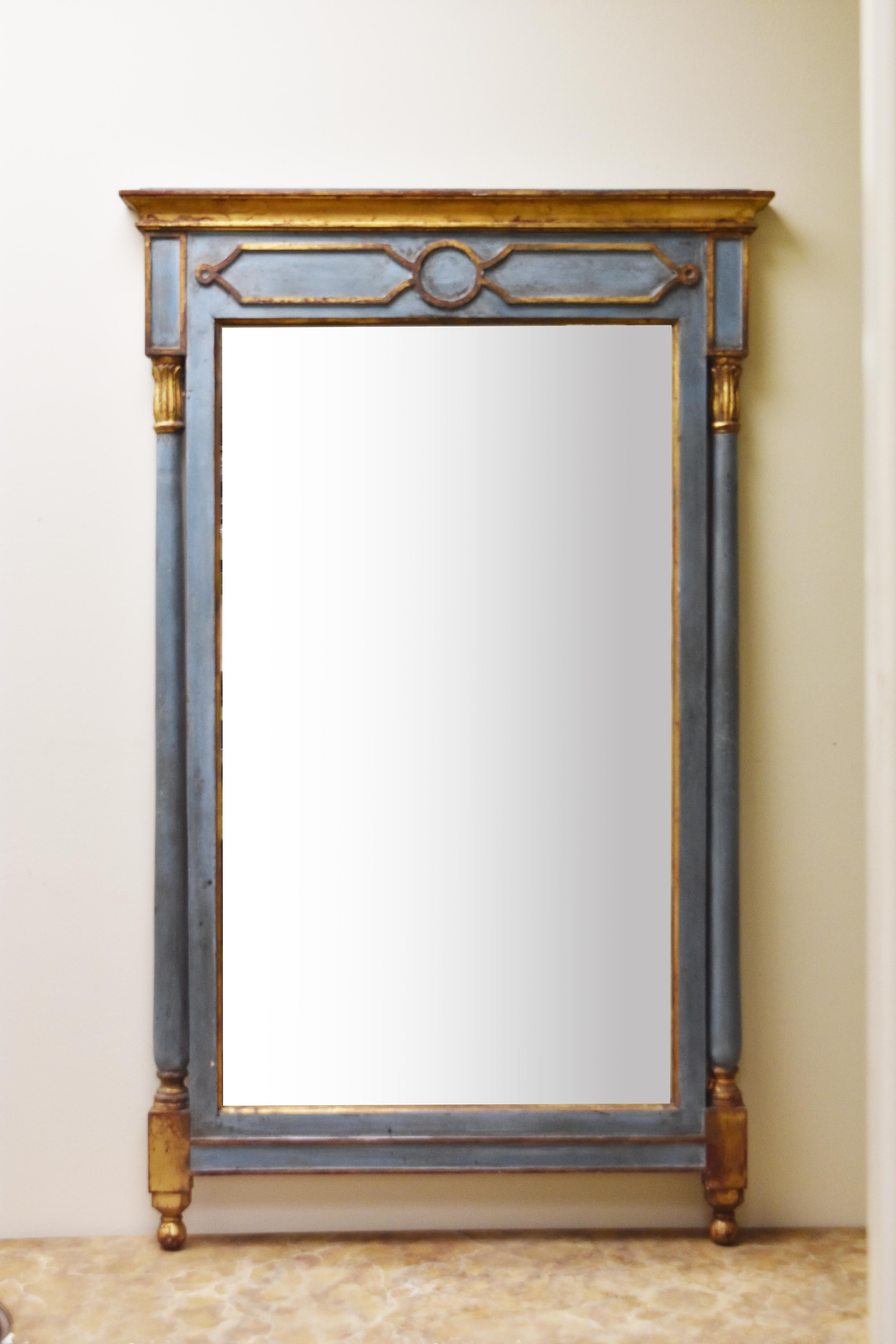 This pair of French mirrors is finished with blue paint and gilt accents. The glass appears to be old with minor imperfections.