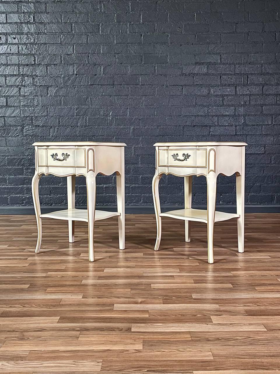 Condition: Original Vintage Condition

Materials: Original Cream Painted Wood

This exquisite pair of Vintage French Provincial Style Night Stands embodies the timeless elegance of 18th-century French countryside design. Crafted with graceful