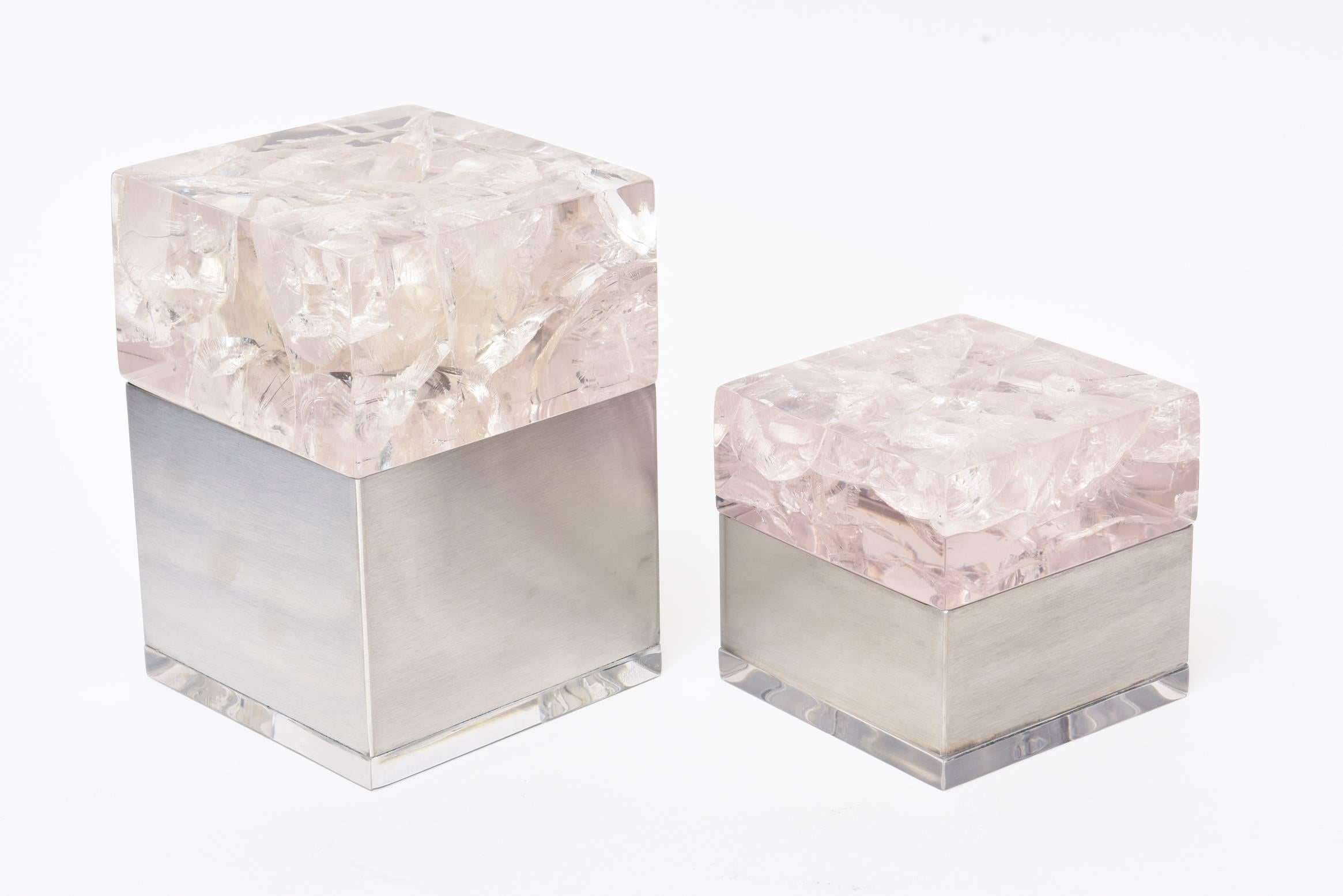 These amazing sculptural French vintage Pierre Giraudon pair of boxes are composed of an encasing of fractal embedded lucite as the tops that sit on brushed stainless steel bottoms with a small Lucite base. They are more on the rare side. The two