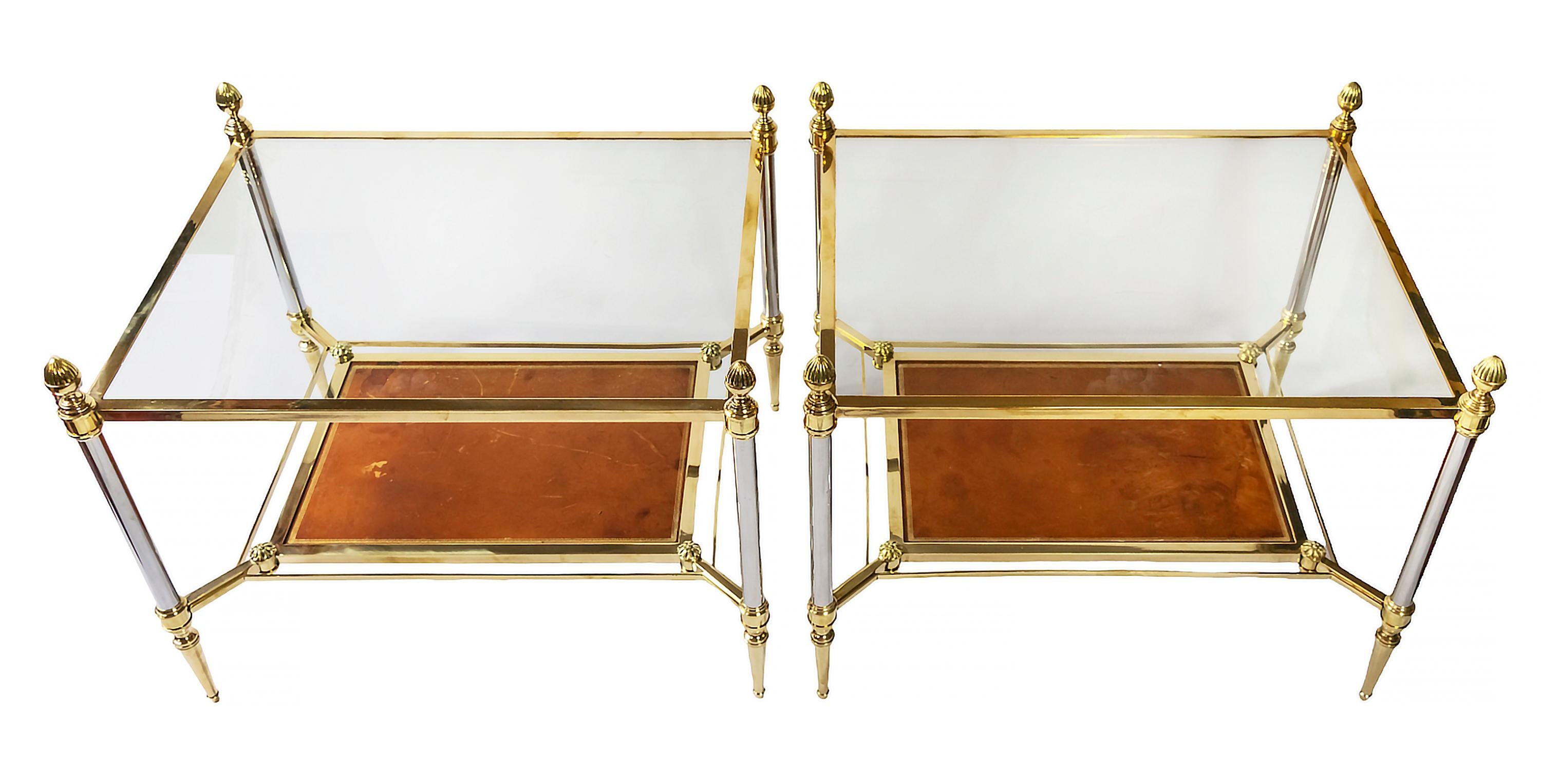 Pair of French vintage side tables by Maison Jansen form 1970's.
The base is in brass and metal decorated with cones and rosettes.
The top is covered with transparent glass and down shelve is in leather decorated/stamped with gold decor ornament.