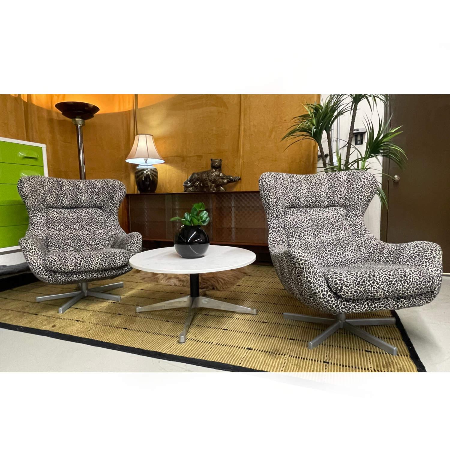 Pair of super sexy lounge chair in plush, fuzzy leopard print wool material. Recently reupholstered with tons of life on the fabric. The ultra modern chair is in the style the iconic Arne Jacobsen world recognized, timeless design Egg Chair. 5-star