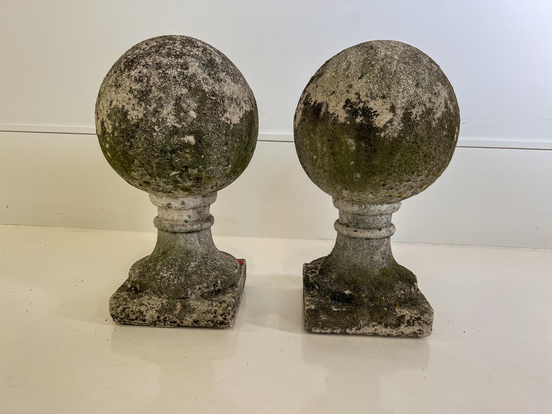 Always a classic: A pair of matching orbs on pedestals. These are concrete with a weathered and mossy patina.