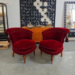 Coppia di poltroncine vintage in velluto rosso granato con rotelle in ottone e gambe in betulla