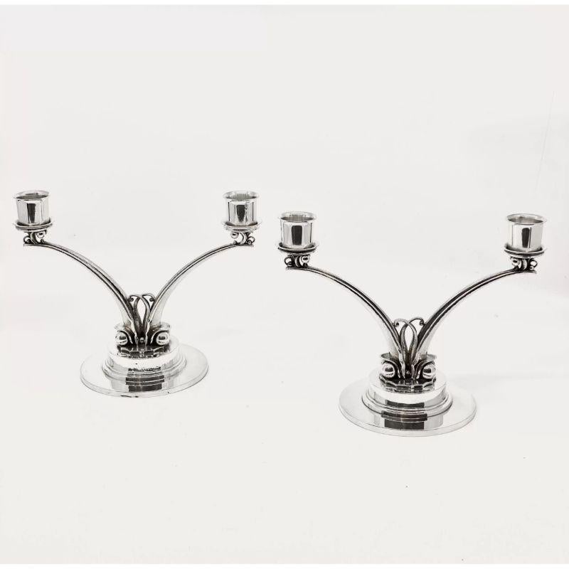 A pair of sterling silver Georg Jensen Art Deco candelabra, design #278 by Harald Nielsen from circa 1928. Harald Nielsen translates the classic Georg Jensen floral decoration to the more minimalistic Art Deco design language.

Additional