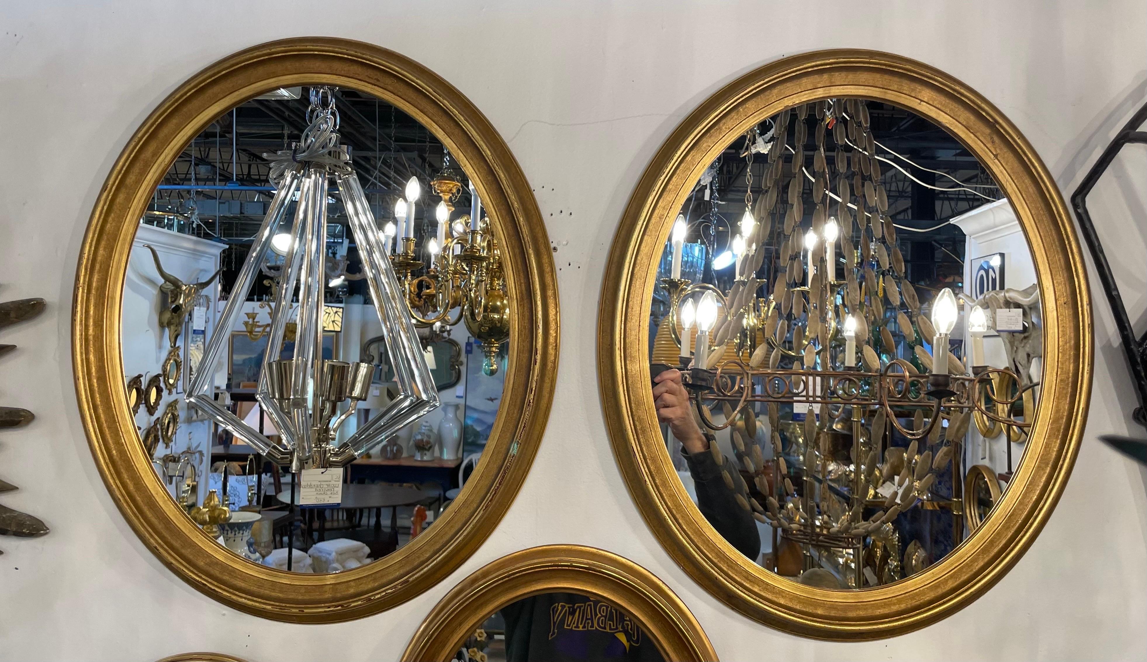 Pair Italian gilt oval mirrors. Unique two tone gilt finish. Each mirror is 23