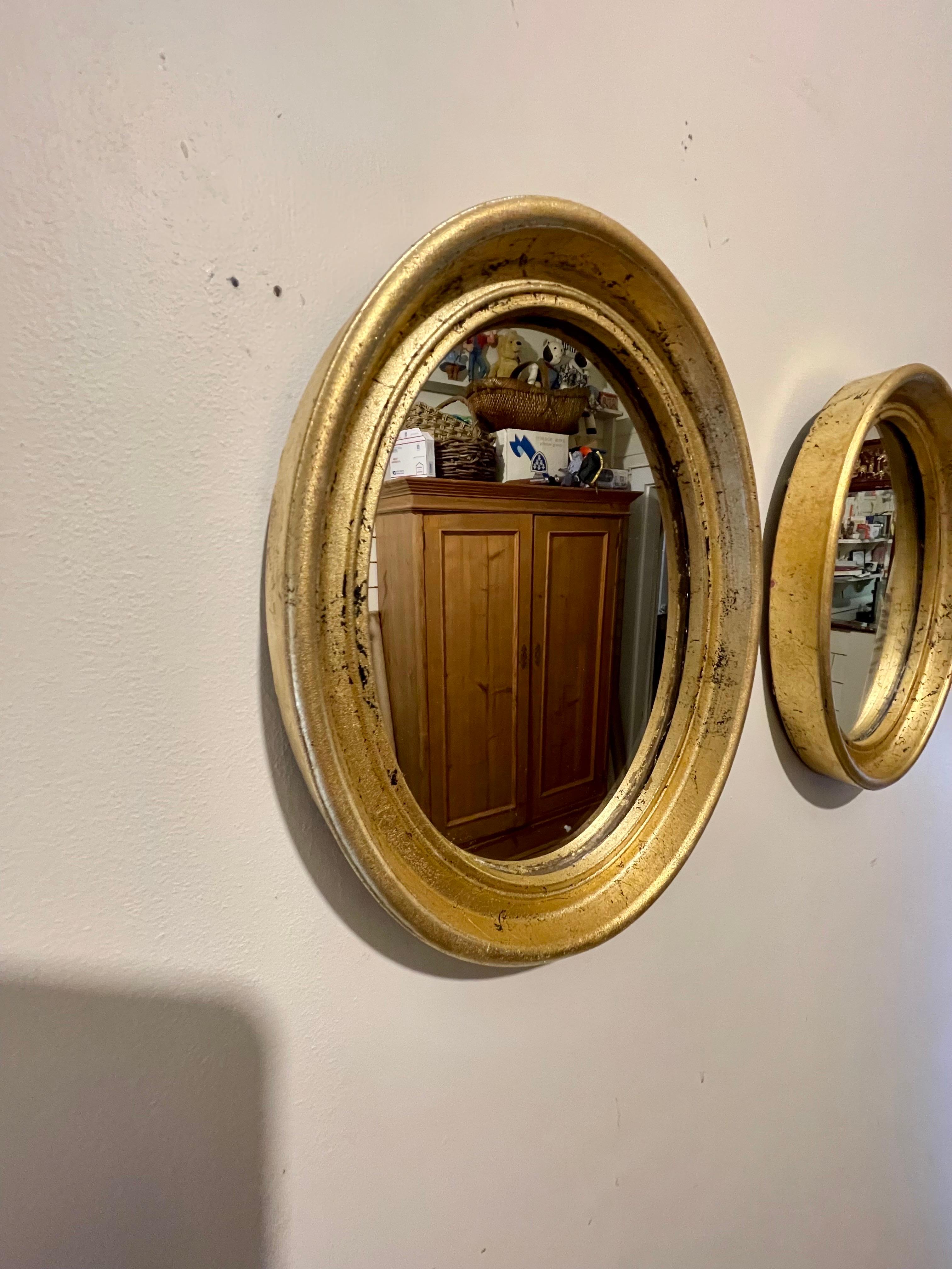 20th Century Pair Of Vintage Gilt Oval Italian Mirrors For Sale