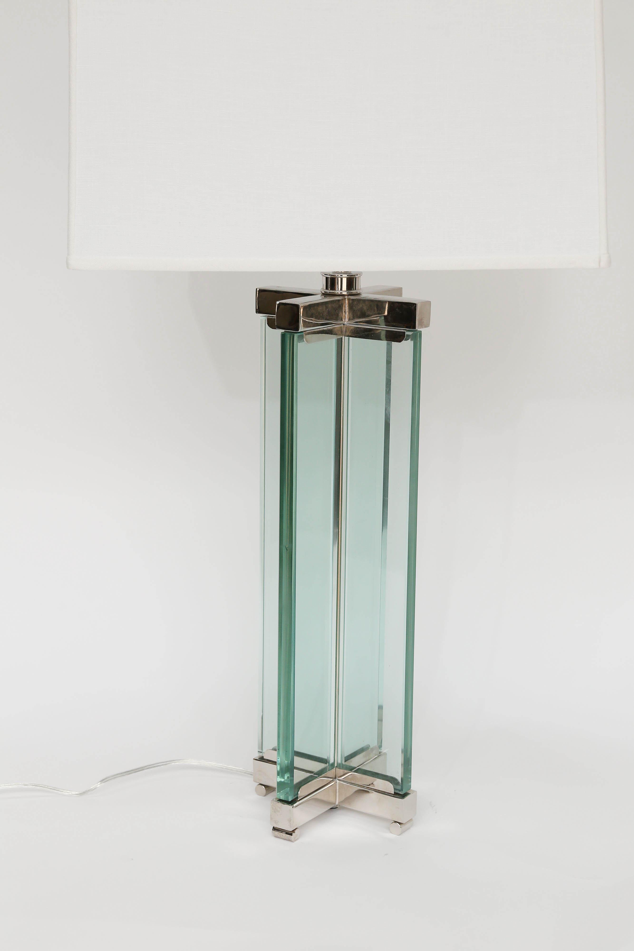 Lovely pair of midcentury English glass and chrome lamps. With a beautiful green tint to the .75 inch thick glass and chrome detail these lamps will add a touch of modern or complete the modern look to any room. Shade dimensions: 17.25