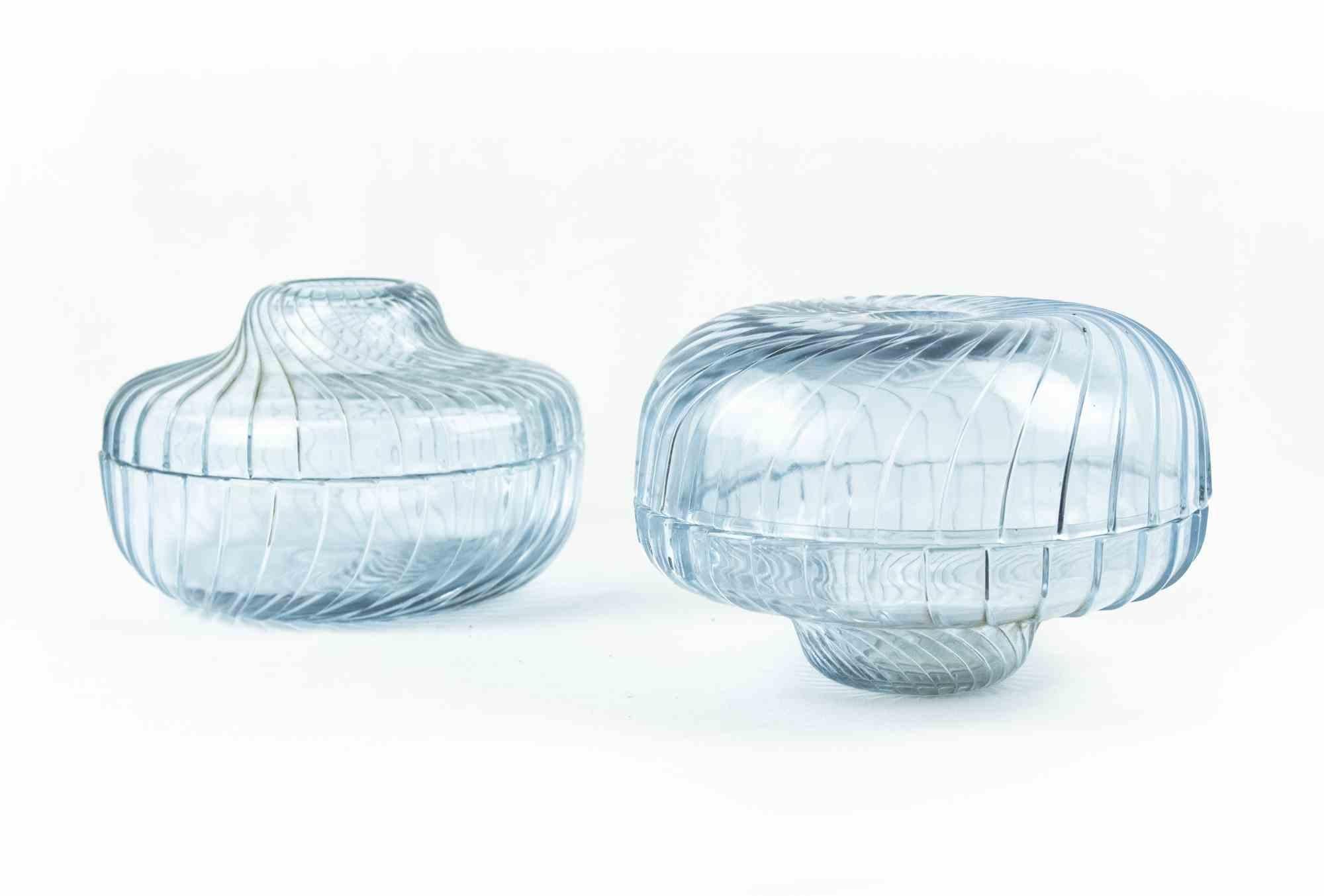 Pair of glass containers is an original decorative object realized in the Second half of the 20th Century.

Made in Italy. 

Art Glass.

The objects are decorated with a spiral light violet decoration.

Mint conditions.
