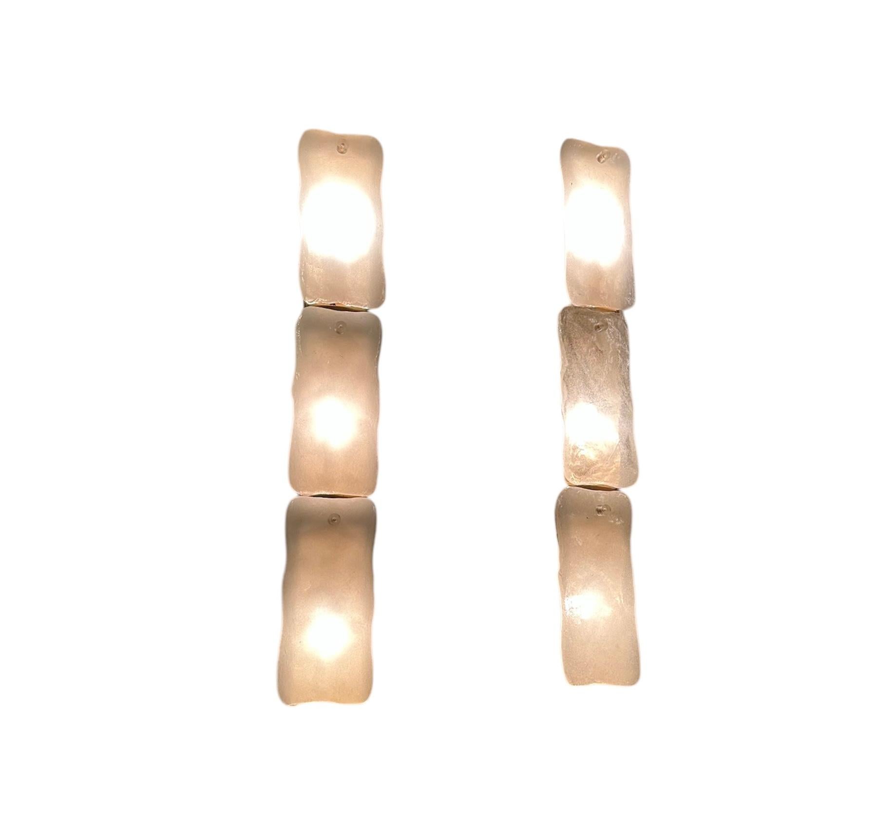 A stylish and extremely well made pair of vintage glass wall sconce lamps by Kaiser Leutchen. They were made in Germany, they date from around the 1960’s.

The quality is superb, they are large and very impressive. Each frame has three textured