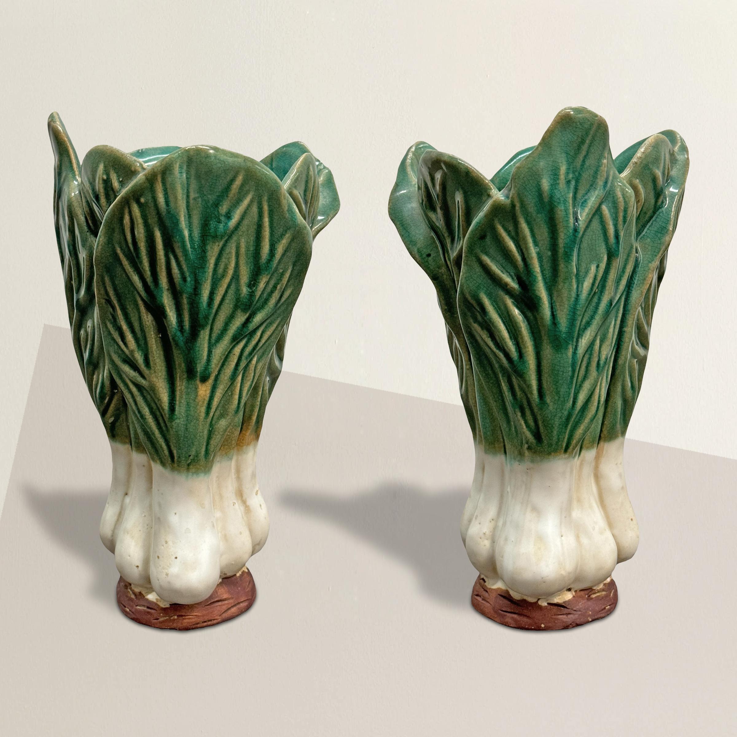 This charming pair of vintage 20th-century ceramic vases captures the natural beauty of bok choy plants, offering a playful yet elegant touch to your décor. Expertly crafted and glazed to mimic the vibrant green leaves and crisp white root ends,