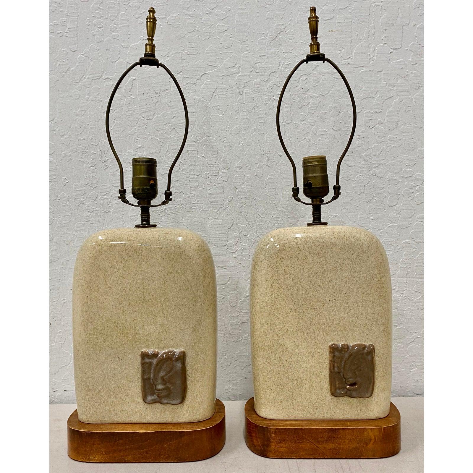 Pair of vintage glazed ceramic lamps with Mayan inspired ceramic medallions

Fantastic pair of vintage table lamps, circa 1940s-1950s.

A raised Mayan inspired medallion is on the front and back of each lamp.

The ceramic lamps sits atop
