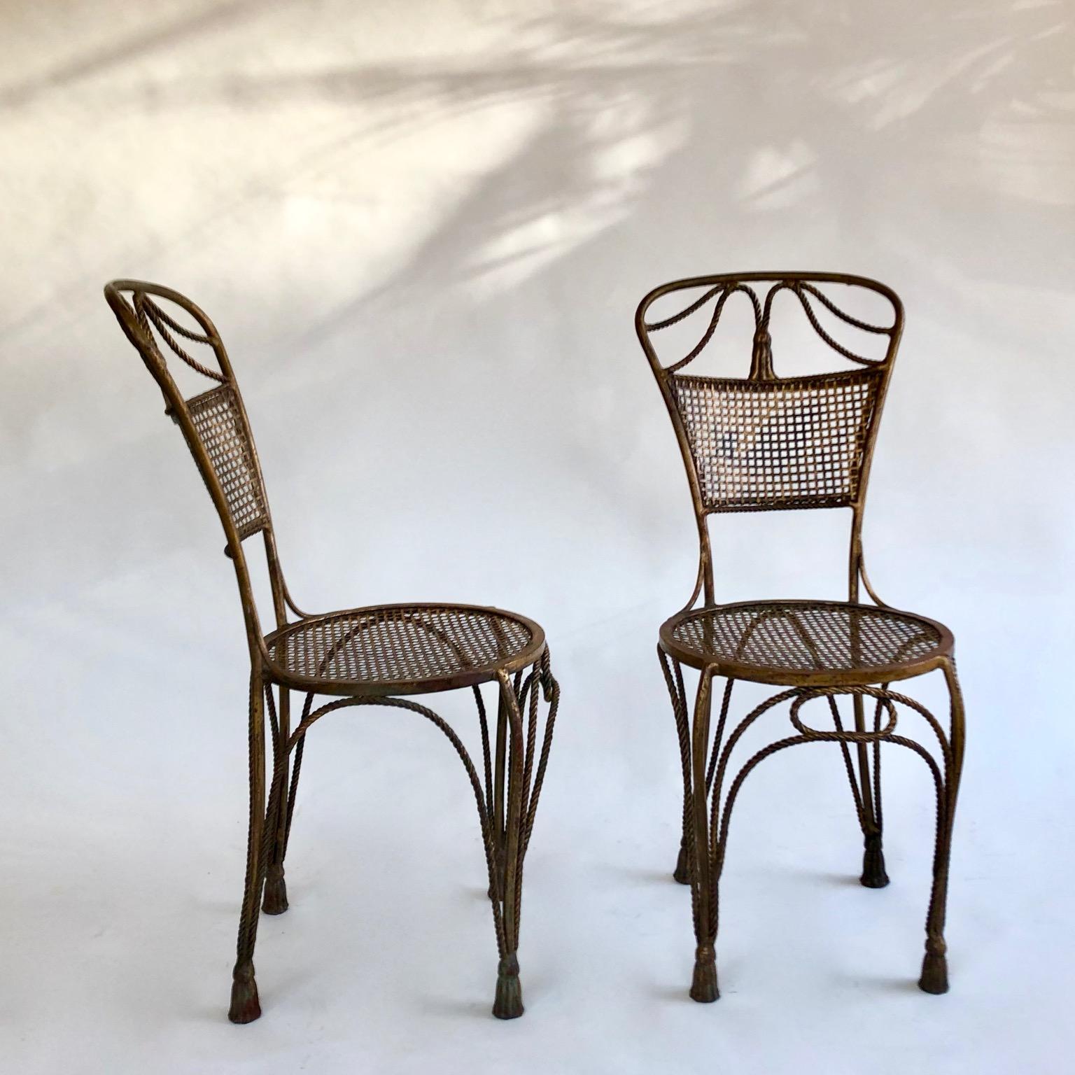 A pair of gilded metal Italian rope and tassel Hollywood Regency chairs, circa 1950s.
4 chairs available, the price is for one pair.