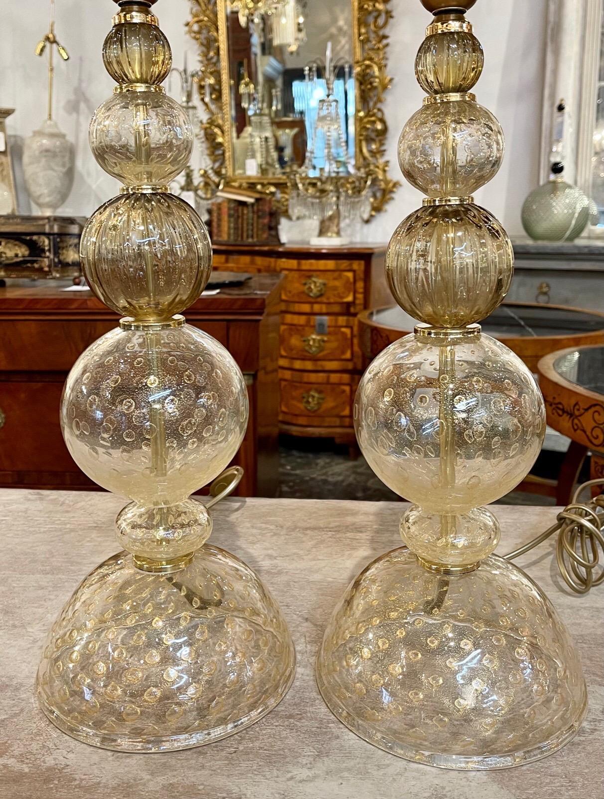 Lovely pair of vintage gold Murano glass lamps. Featuring graduated balls with beautiful flecks of gold throughout the glass. So pretty!!