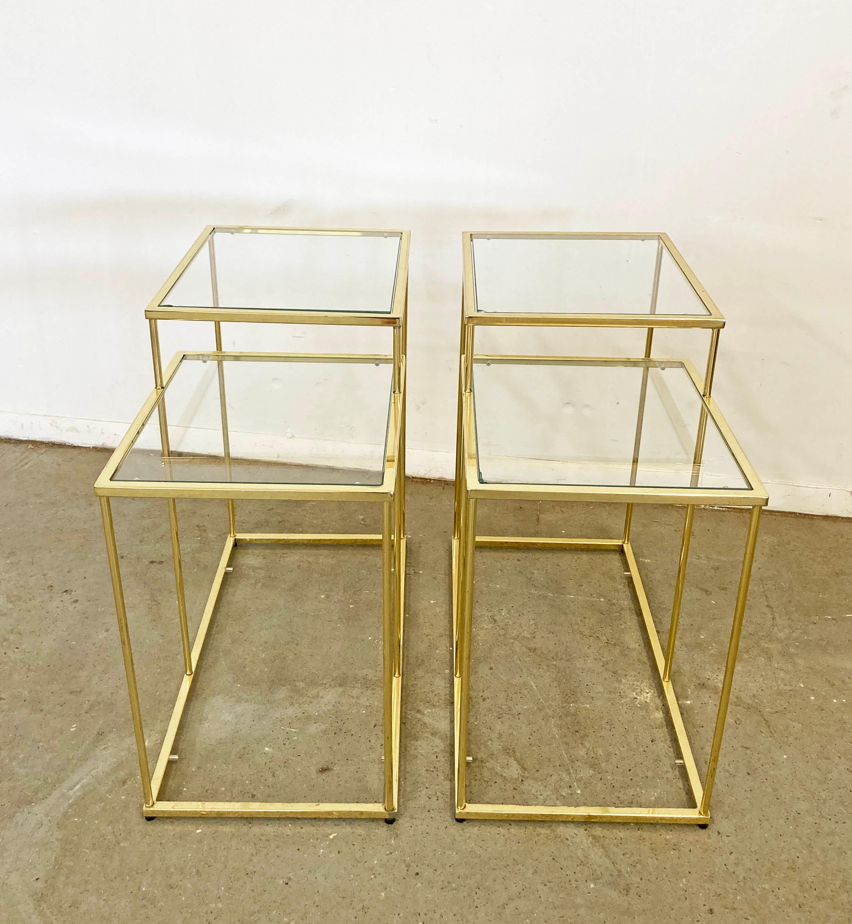 Offered is a pair of vintage tiered end tables with glass tops. These tables have great lines and are sure to class up any joint! Features golden chrome bases with glass tops. Looks like they have three tiers, but the bottoms are missing glass tops.