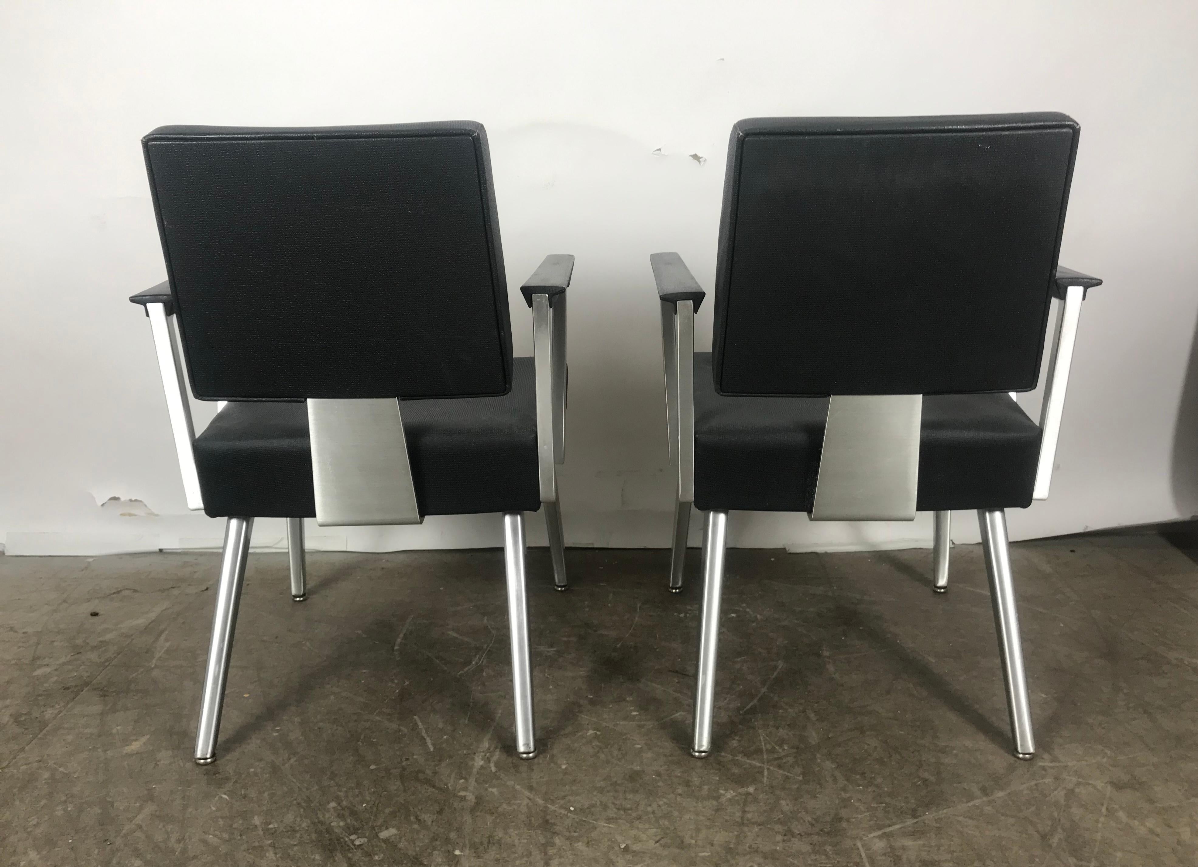 Pair of vintage good form brushed aluminum companion armchairs, lounge chairs in original black vinyl with top-stitch detail and flex/foot glides. Amazing original, like new condition! gleaming aluminum, Exclusive spring back makes sitting in this