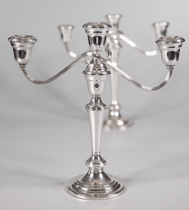 A stunning pair of Gorham silverplate 3 light convertible candelabras. Maker's mark on reverse. These fine candle holders are solid and heavy with a sleek design, perfect for the modern home. They would make a gorgeous centerpiece for a dining table