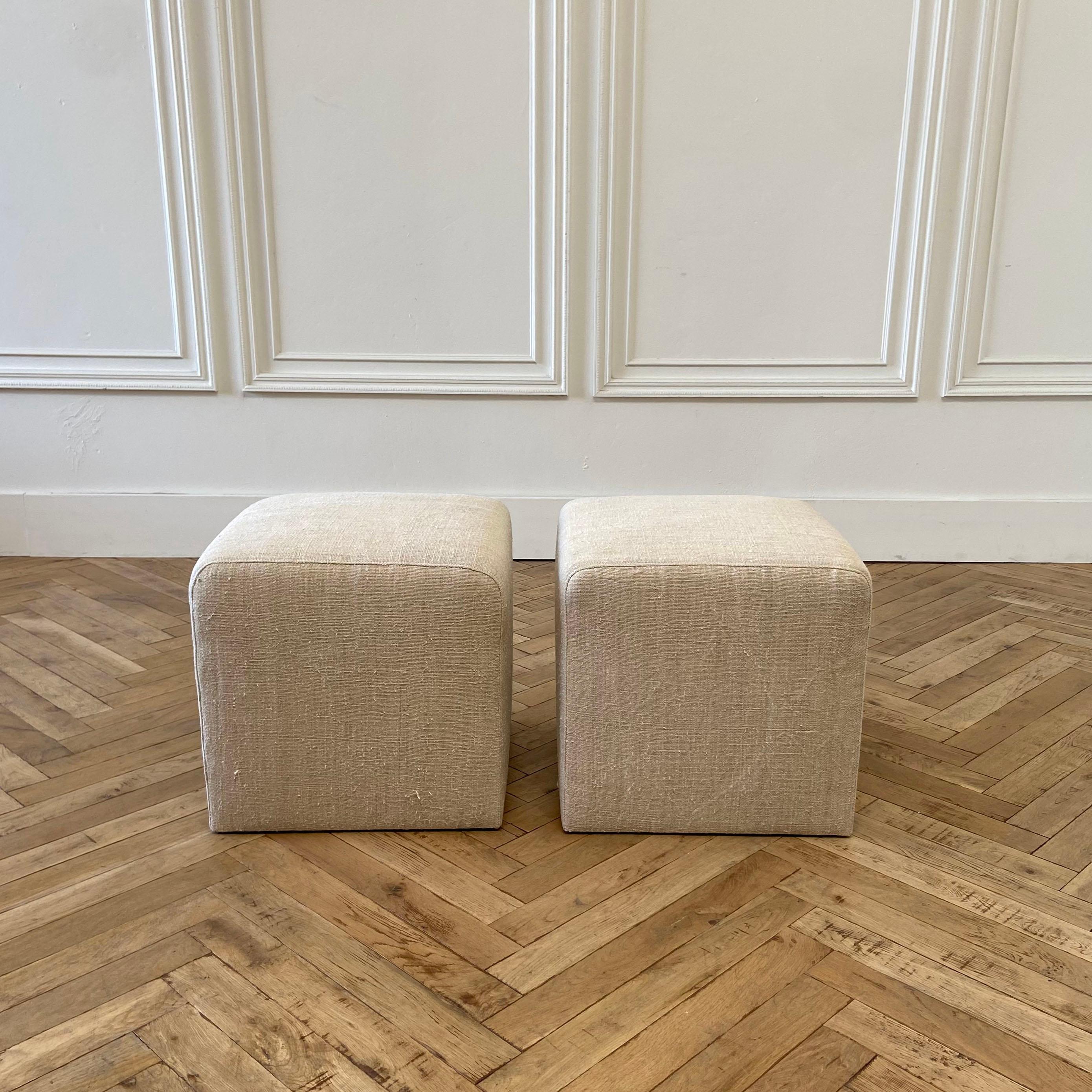 Pair of vintage grain sack upholstered nubby linen cube ottomans
Qty. 2, sold individually
These cubes are custom made by bloom home Inc. and have a wood frame construction, high density quality foam. The material is antique or vintage European