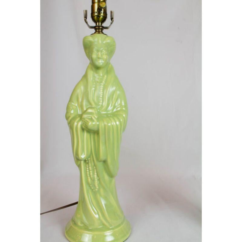 Pair of figural lamps. Lime green figures of man and woman in a western interpretation of traditional Asian costume.

Dimensions: 
Height: 21
Width (Diameter): 6