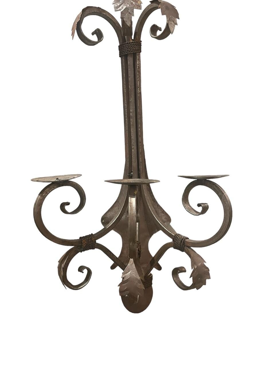 Elevate your décor with this exquisite vintage pair of handcrafted 3-candle wall sconces, boasting a captivating patina that adds character and charm. Each sconce is a testament to artisanal craftsmanship, meticulously shaped and finished to